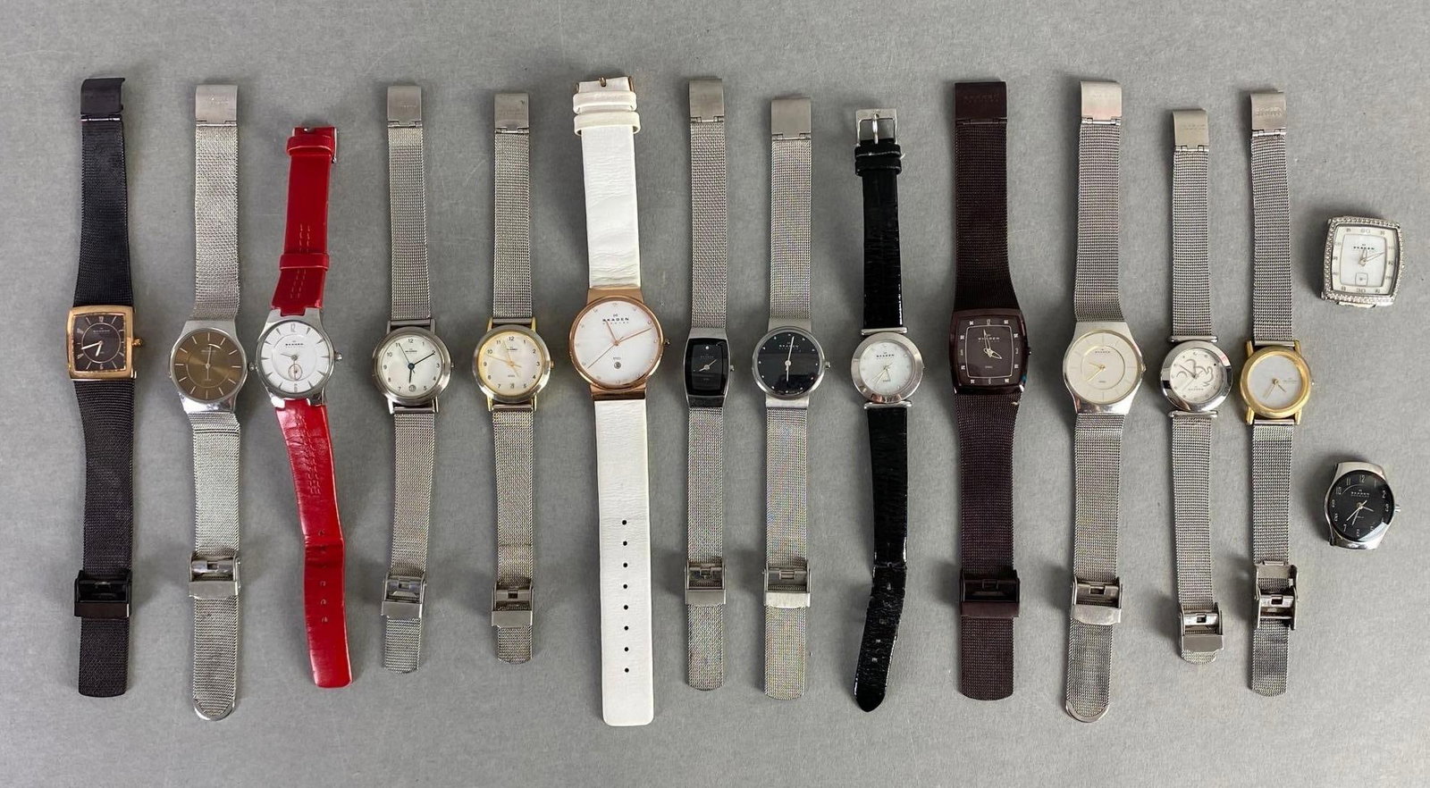 Group of Skagen Denmark Wristwatches: Includes watches and faces, Unknown working condition, Longest watchband measures 9 inches long.