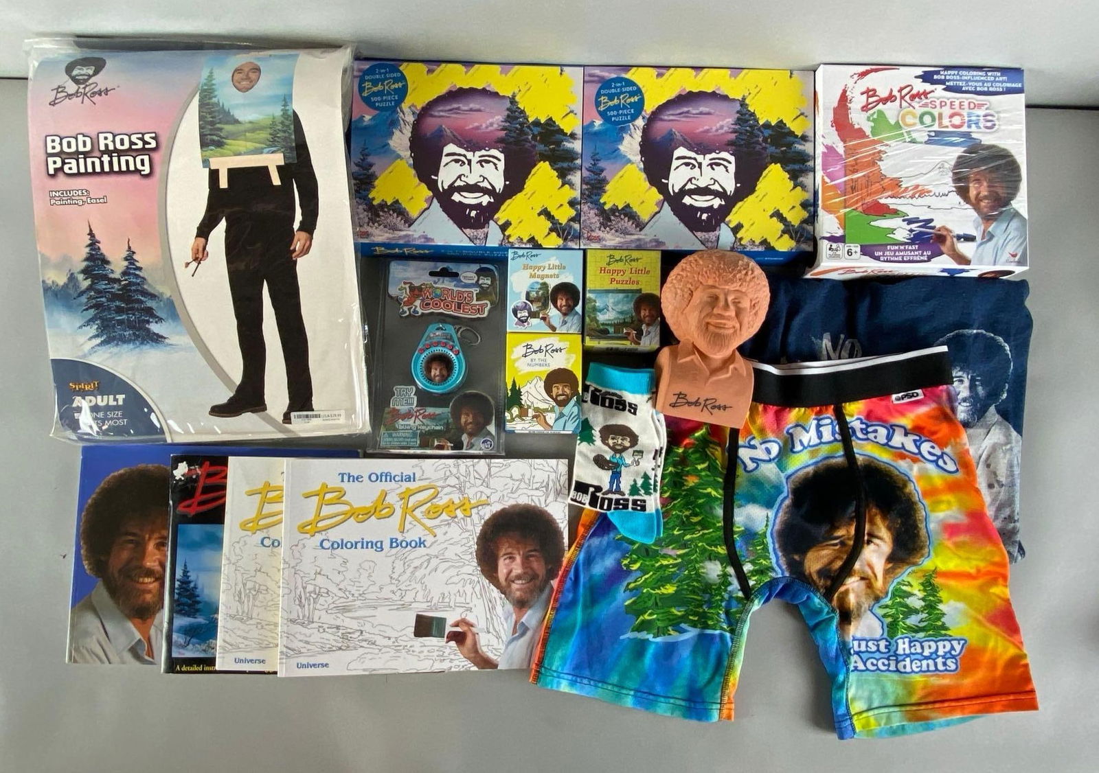 Group of 16 Bob Ross Assorted Items: Include clothing, books, costume and more, largest measures 15 x 11 1/2 inches