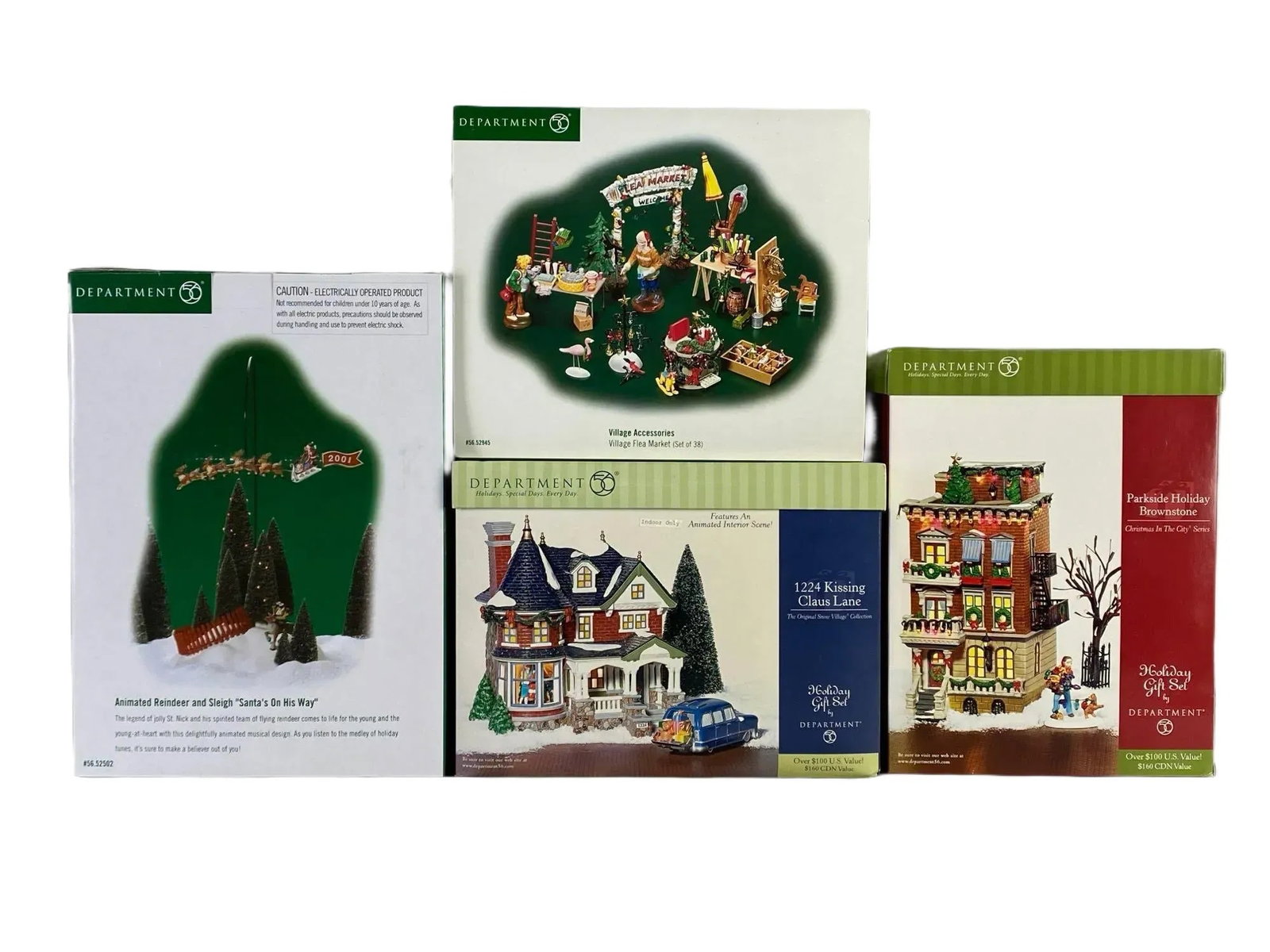 Group of 4 Department 56 Christmas Village Buildings: Includes Animated Reindeer and Sleigh Santas on His Way, Village Flea Market, 1224 Kissing Claus Lane, and Parkside Holiday Brownstone, In original boxes, Largest box measures 15 x 11 x 10 inches.