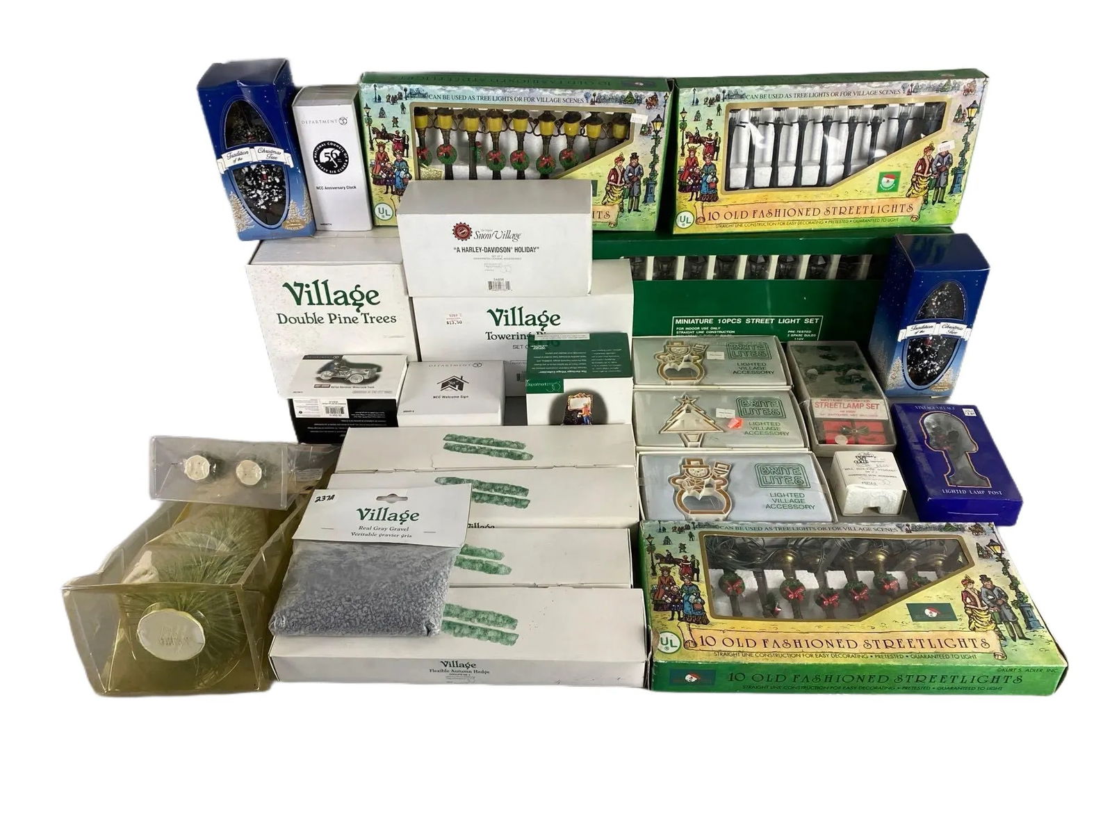 Group of Department 56 Christmas Village Accessories: Includes Old Fashioned Streetlights, Autumn Hedge, Brite Lites, Double Pine Trees, and more, In original boxes, Largest box measures 7 x 18 1/2 x 2 inches.