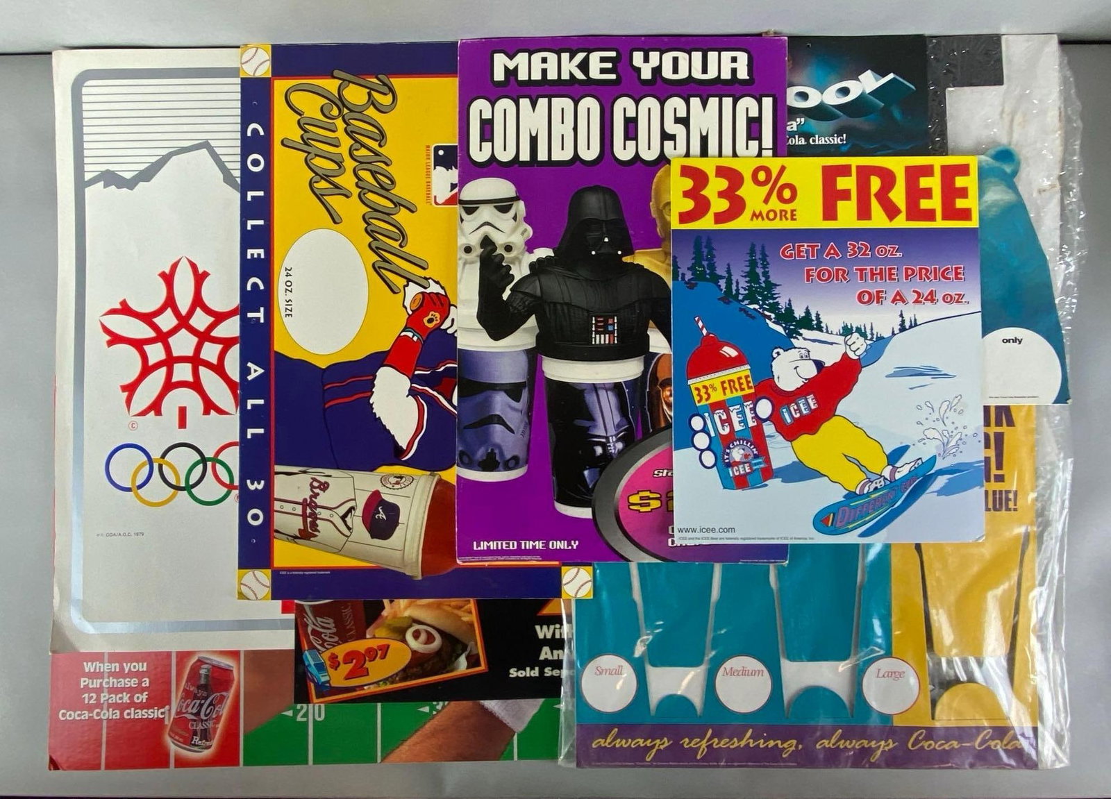 Group of Assorted POP Cardboard Advertising Displays: Includes Coca-Cola, ICEE, Star Wars, Olympics and more, some in original bags, largest measures 18 x 27 inches