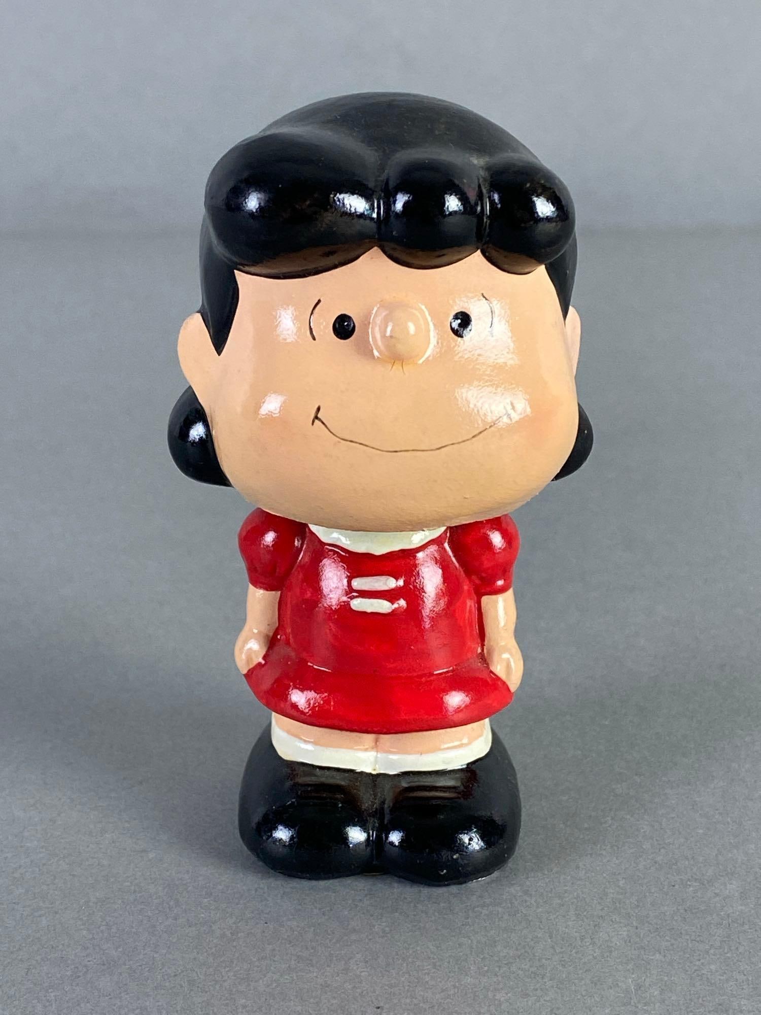 1952 Peanuts Charlie Brown Lucy Plaster Bobblehead: 1952, Made in Korea, Measures 3 3/4 inches tall.