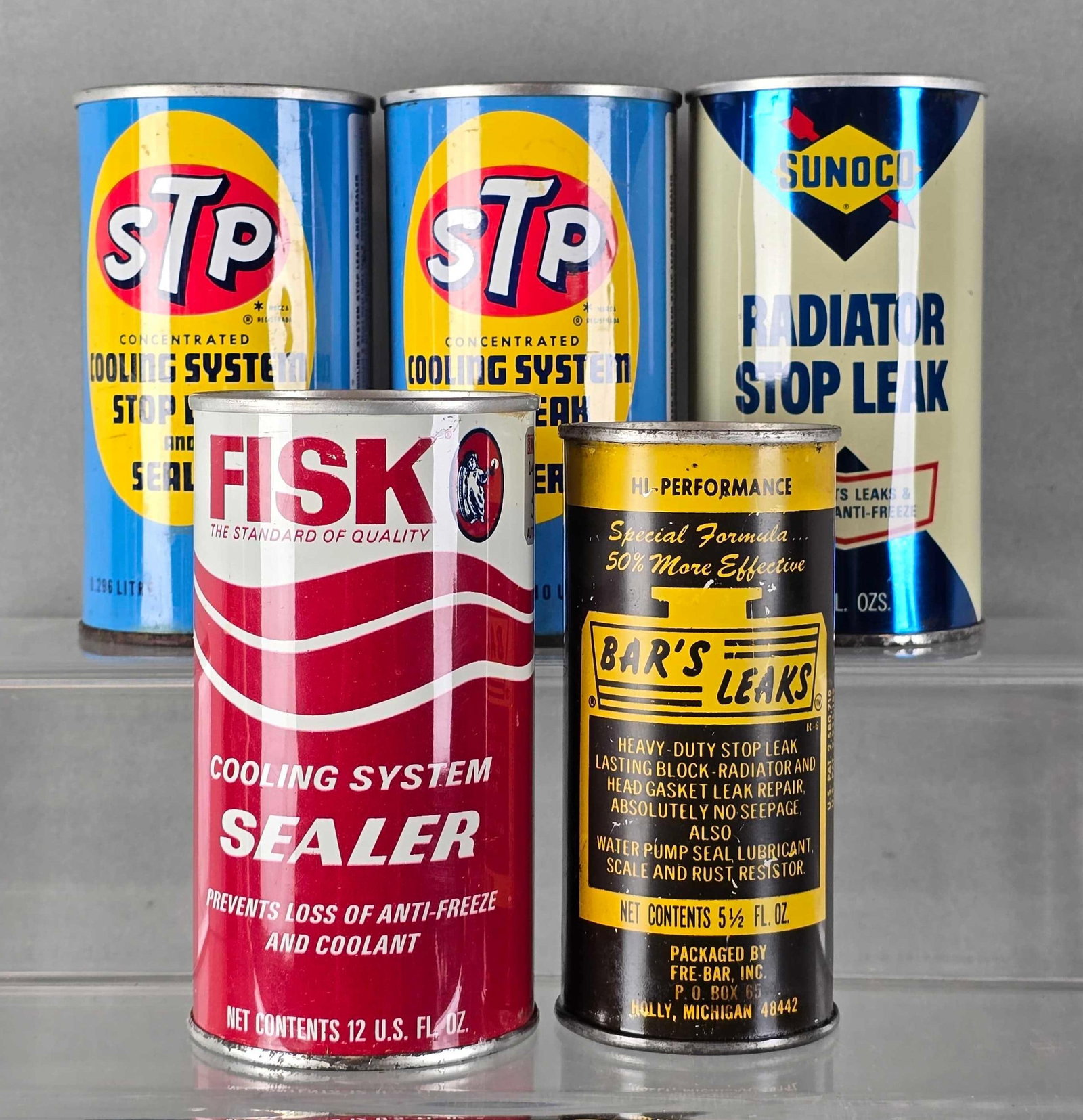 Group of 5 Stop Leak and Sealant Cans: Cans are mostly full, Includrs STP, Fisk, Sunoco and Bars leaks, largest measures 4 3/4 x 2 1/2 x 2 1/2 inches