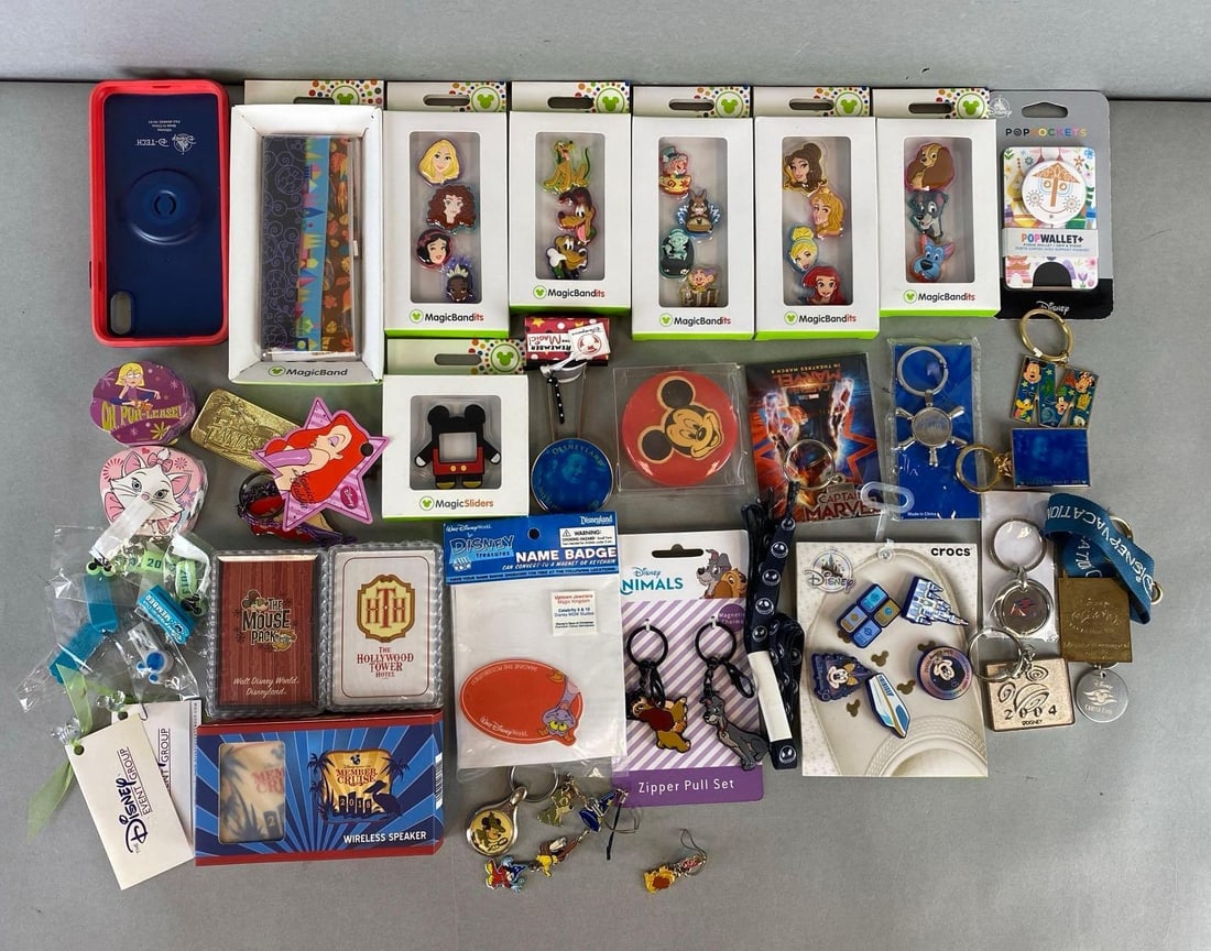 Group of Disney Magic Bands and more: Includes croc charms, keychains, decks of playing cards and more. Largest item measures 3/4 x 8 x 3 3/4 inches.