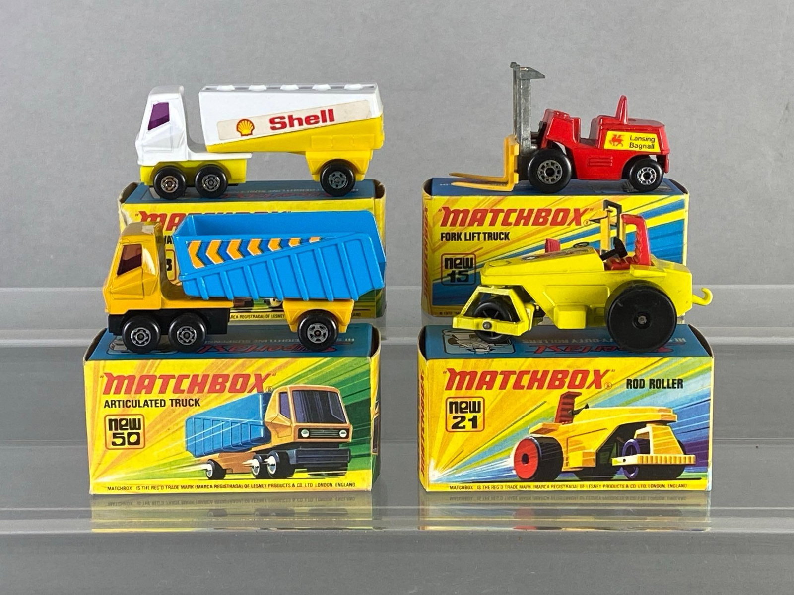 Group of 4 Matchbox Die-Cast Vehicles: With boxes, Includes No. 15 Fork Lift Truck, No. 21 Rod Roller, No. 50 Articulated Truck, and No. 63 Freeway Gas Tanker.