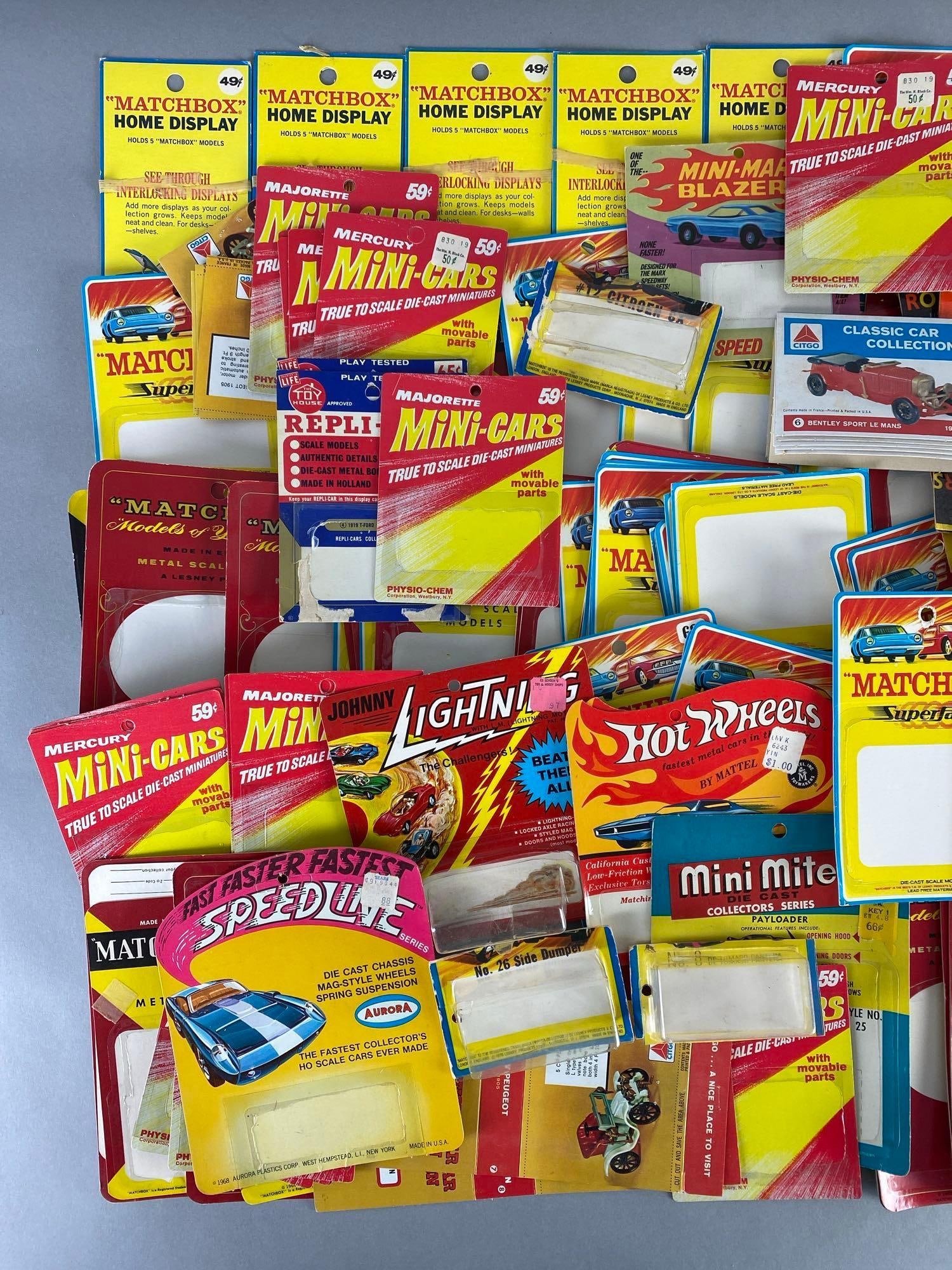 Group of Die-Cast Vehicle Card Backs: Includes Matchbox, Hot Wheels, Johnny Lightning, Majorette, and more, Largest measures 10 1/2 x 3 1/2 inches.