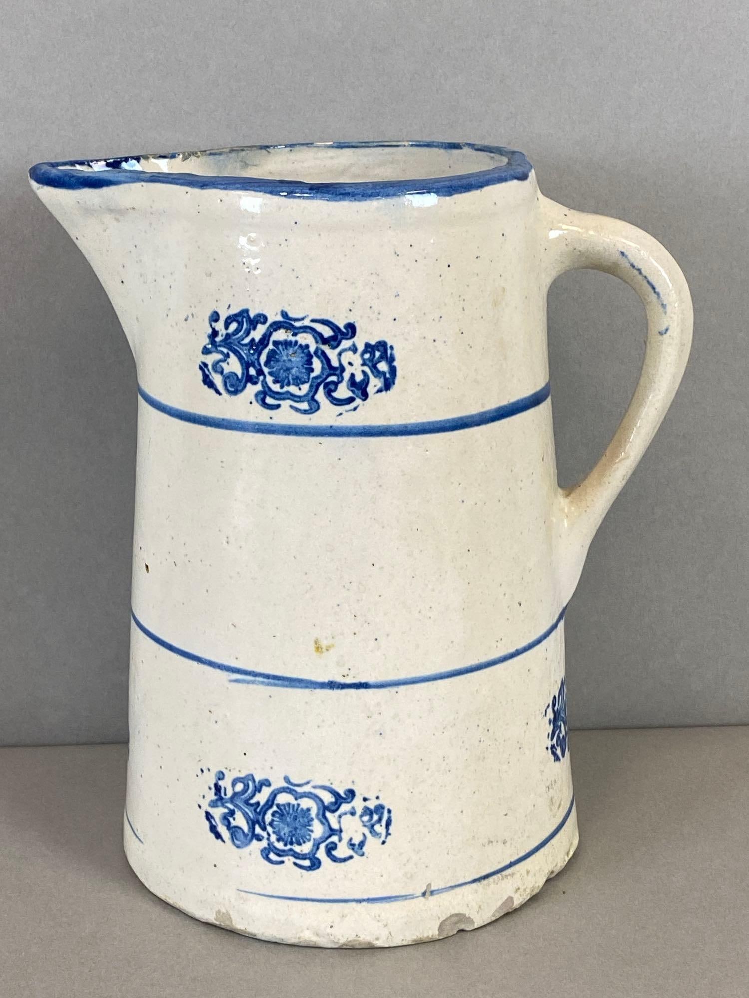 Antique 1/2 Gallon Stoneware Pitcher with Cobalt Floral Motif: Has chips. Measures 8 3/4 x 7 3/4 x 6 inches.
