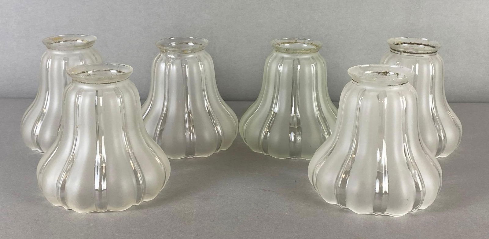 Group of 6 Frosted to Clear Glass Ribbed Striped Lamp Shades: Some fleabites and small chips around rims, All measures 4 3/4 x 4 1/2 x 4 1/2 inches, Fitter measures 2 1/4 inches across.