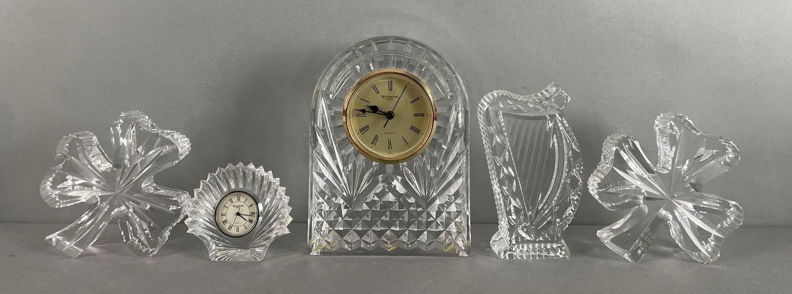 Group of Waterford Crystal Clocks and More: Includes harp, 2 clovers, one is inscribed. Largest measures 6 1/2 x 4 3/4 x 2 inches