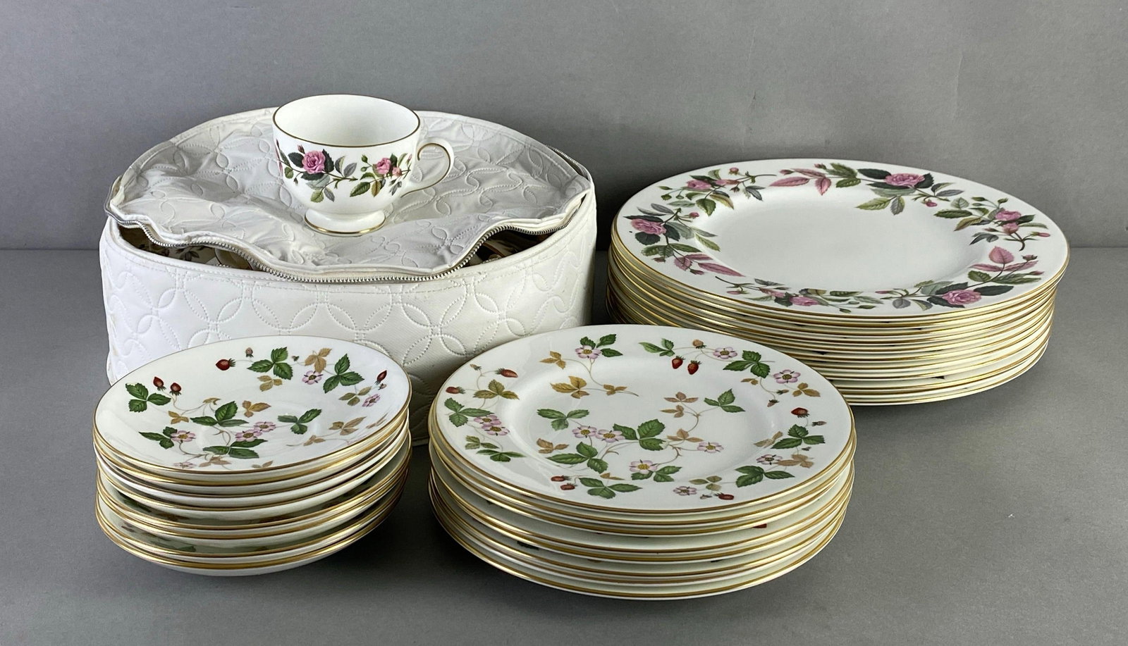 Group of Wedgwood Porcelain Dinnerware: Includes Wild strawberry and Hathaway rose patterns, includes dinner plates, salad plates teacups and saucers, largest measures 11 inches in diameter