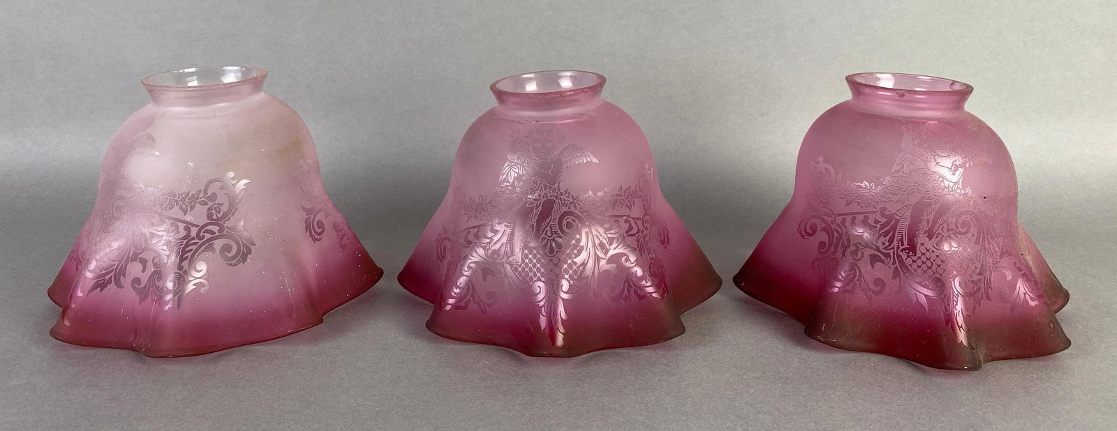 Group of 3 Cranberry Ombre Cupid Acid Etching Glass Lamp Shades: some chips on fittings, each measures 4 1/2 x 5 1/2 x 5 1/2 inches with 2 inch fittings