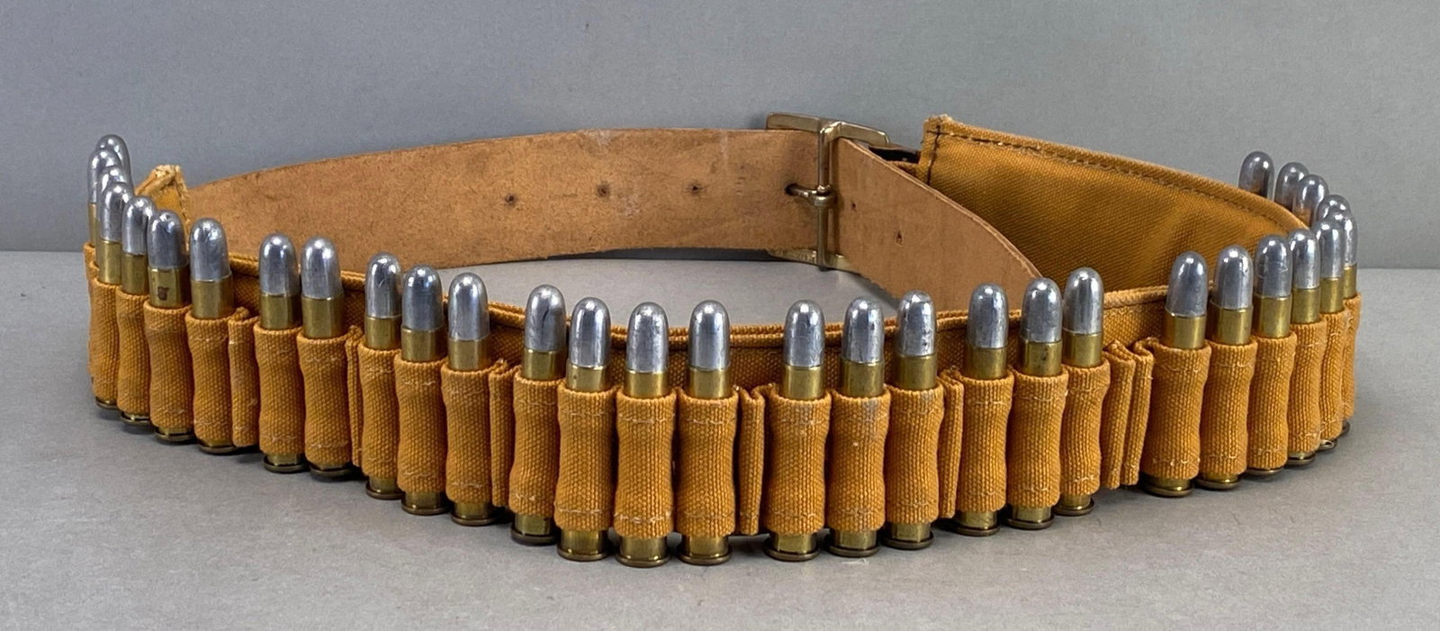 Leather and Canvas Ammunition Belt with .45-70 Cal. Ammunition: Belt measures 43 inches in length , includes 32 rounds of .45-70 Cal. ammunition