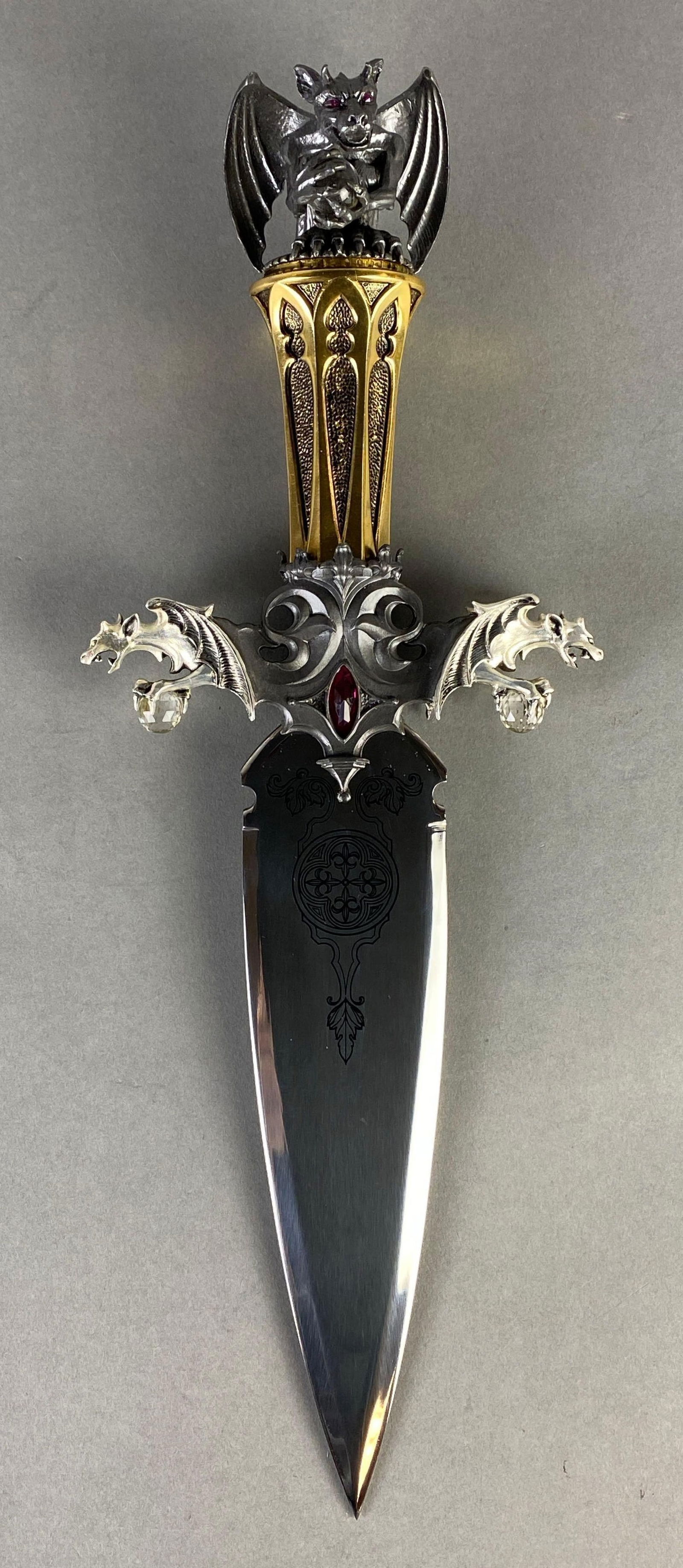 Franklin Mint The Guardian of the Fortress Dagger: By Greg Hildebrandt, With original box and paperwork, Display Mount in original packaging, Dagger measures 15 1/2 inches long, Blade measures 9 inches long, Box measures 6 1/2 x 22 x 12 1/2 inches.