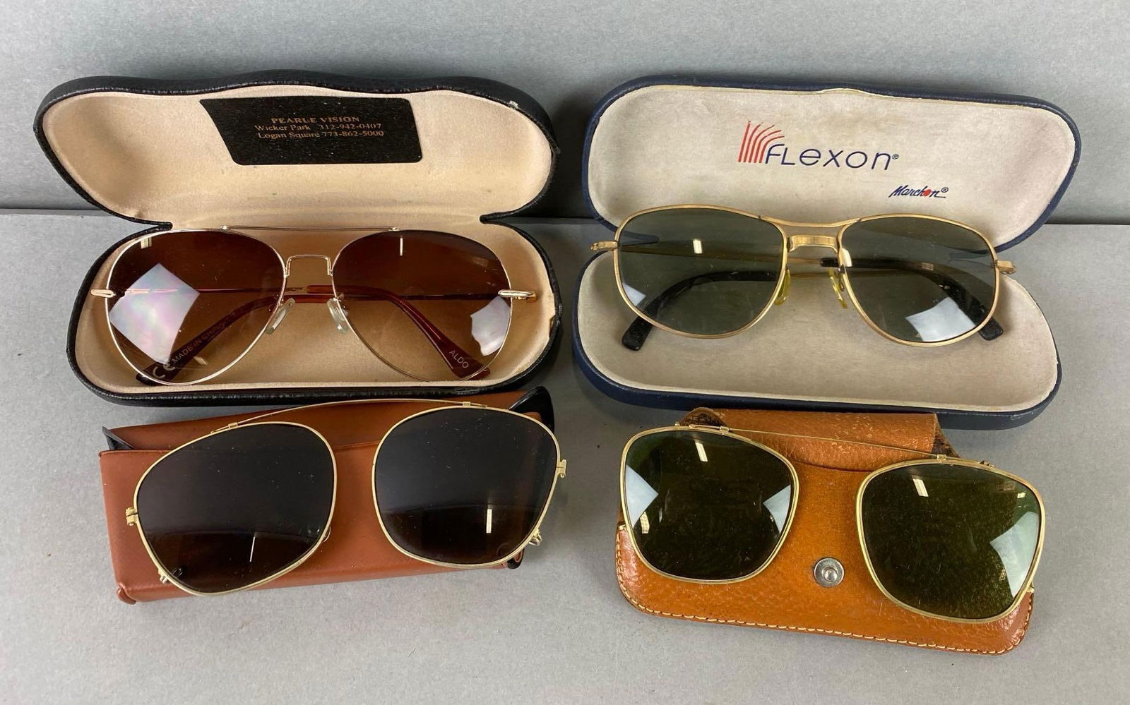 Group of 4 Sunglasses and Cases: 2 are clip on and 2 are regular sunglasses. Largest case measures 1 1/4 x 6 x 2 3/4 inches.
