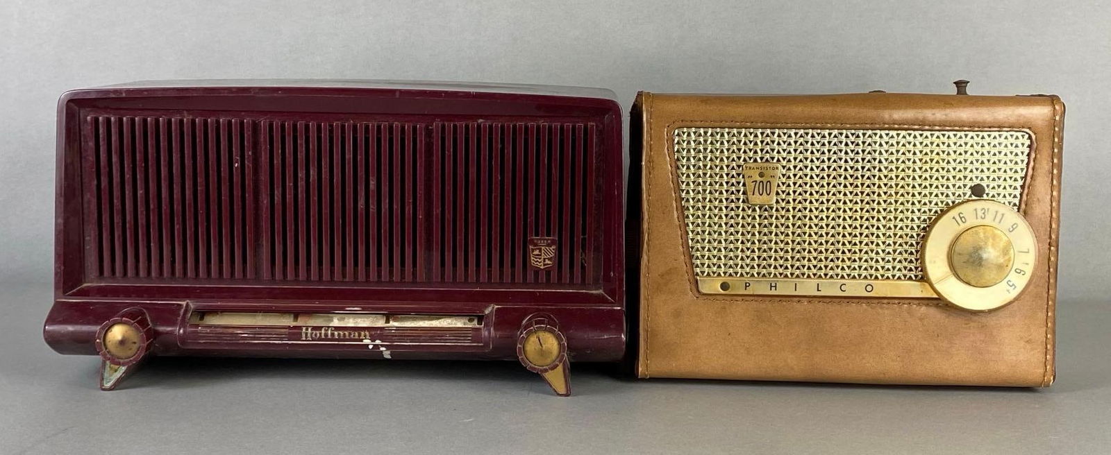 Group of 2 Vintage Radios: Includes Philco Transistor 700, and Hoffman, Not in working condition, Largest measures 6 3/4 x 13 x 7 1/2 inches.