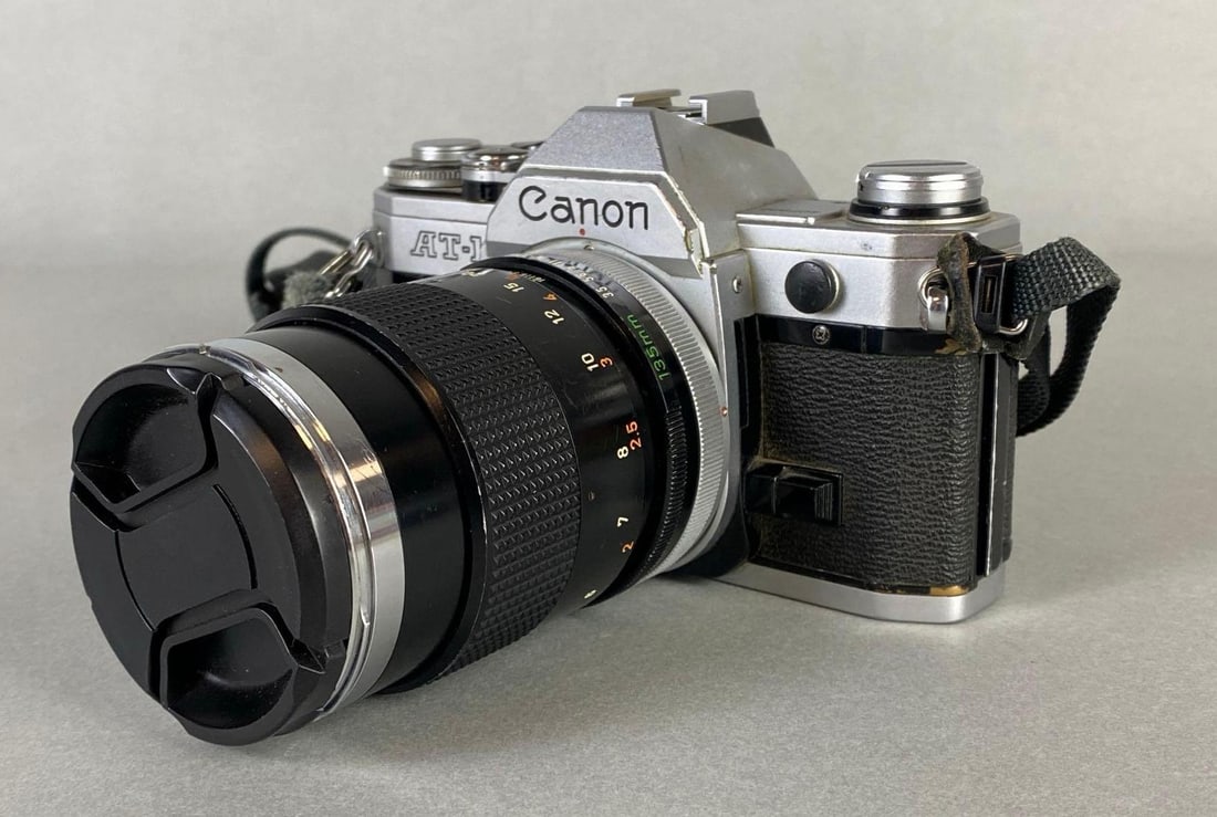 Canon AT-1 Camera with 135mm Lens: Untested, measures 6 x 6 x 3 3/4 inches with lens.