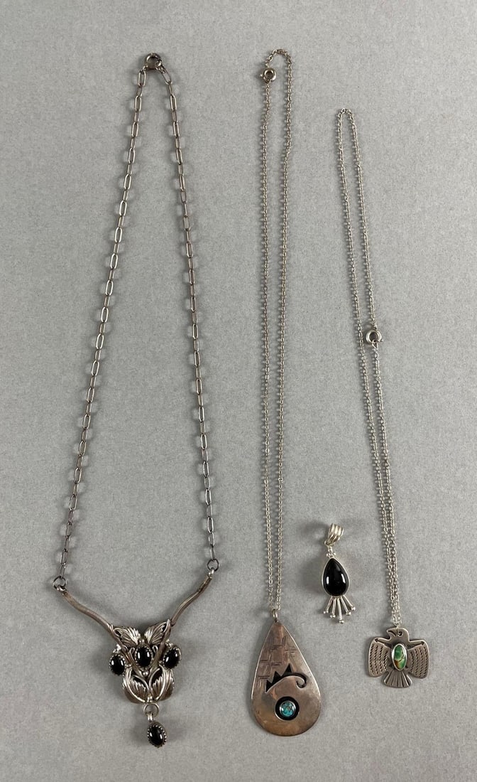 Group of 4 Native American Sterling Silver Necklaces: Includes black onyx , and turquoise. Largest pendant measures 2 1/2 x 2 1/2 inches