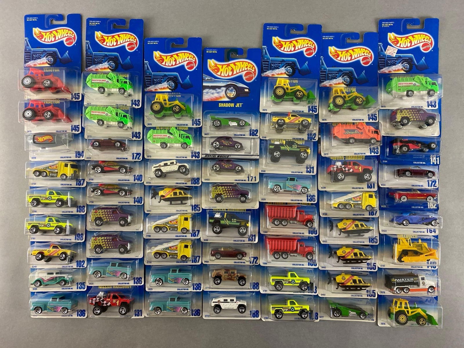 Group of 50+ Mattel Hot Wheels Die-Cast Vehicles: Includes tractor, recycling truck, shadow jet and more, new in original packaging