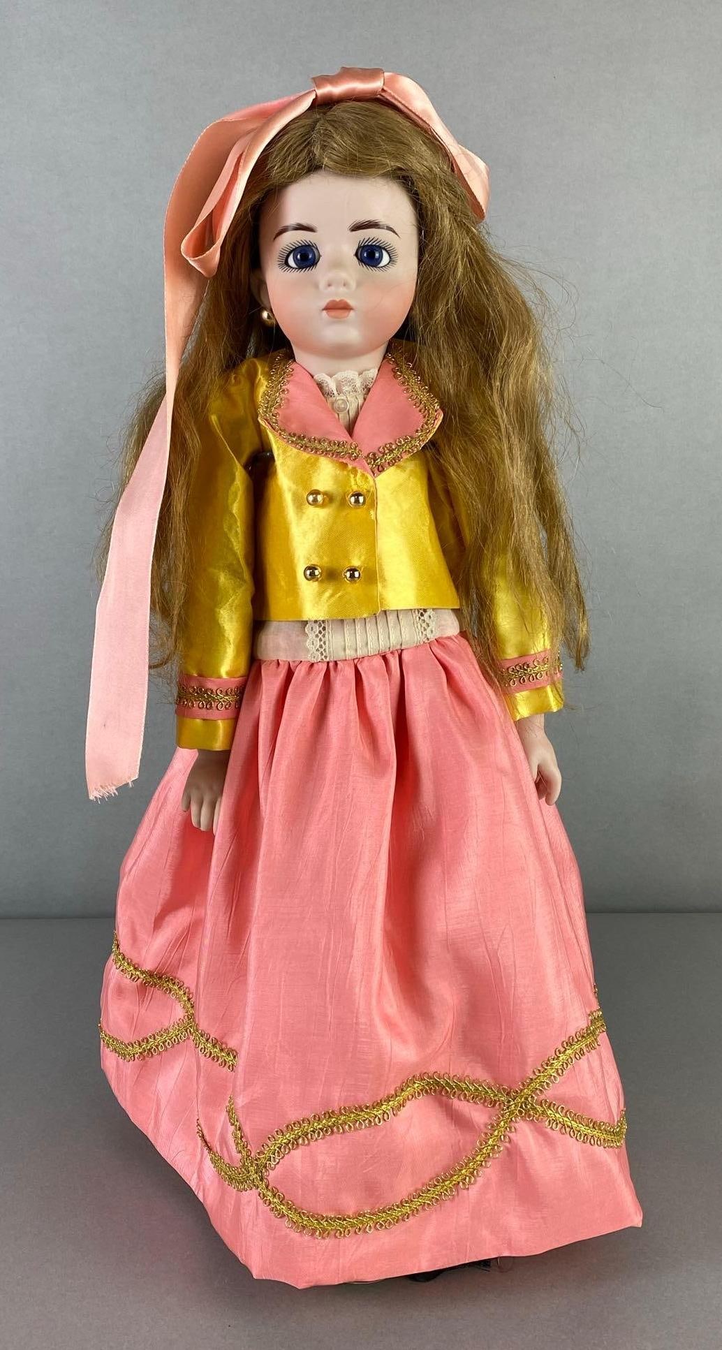 Antique Marquee Girl Porcelain Doll: 20 inches tall, Marked 12, Open blue eyes, Closed mouth, Head turns, Jointed body, Pink skirts with yEllie and pink jacket, Doll stand not included.