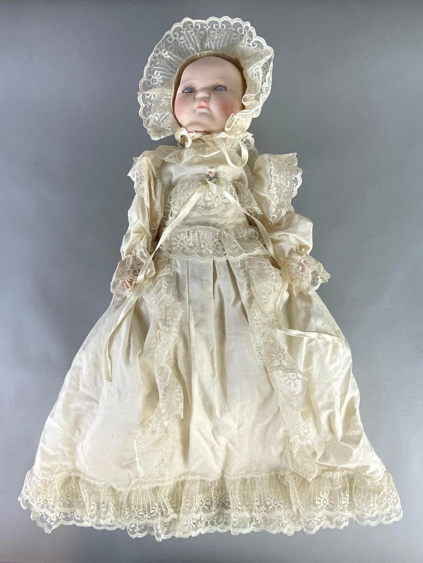 Century Doll Co. Kestner Porcelain Head Baby Doll: 17 inches tall, Porcelain head and limbs, Cloth body, Cotton and lace dress, Painted blue eyes, Closed mouth.