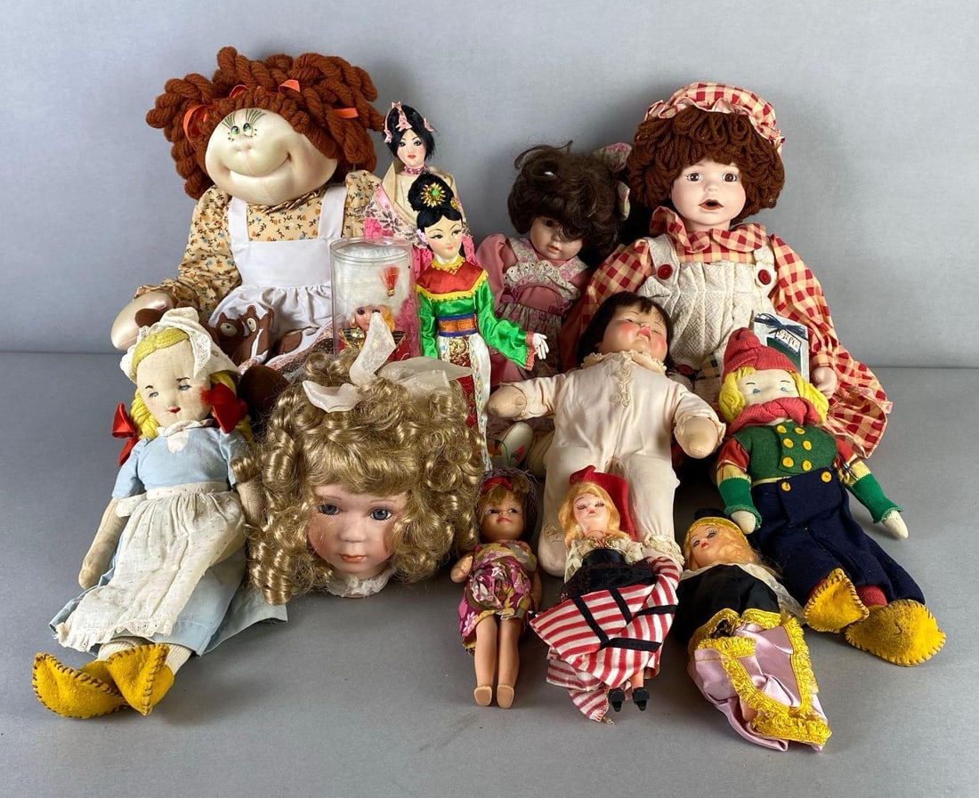 Group of Assorted Dolls: Includes cloth dolls, Madame Alexander Huggums, vinyl dolls, and more, Some just parts, Largest measures 23 inches tall.