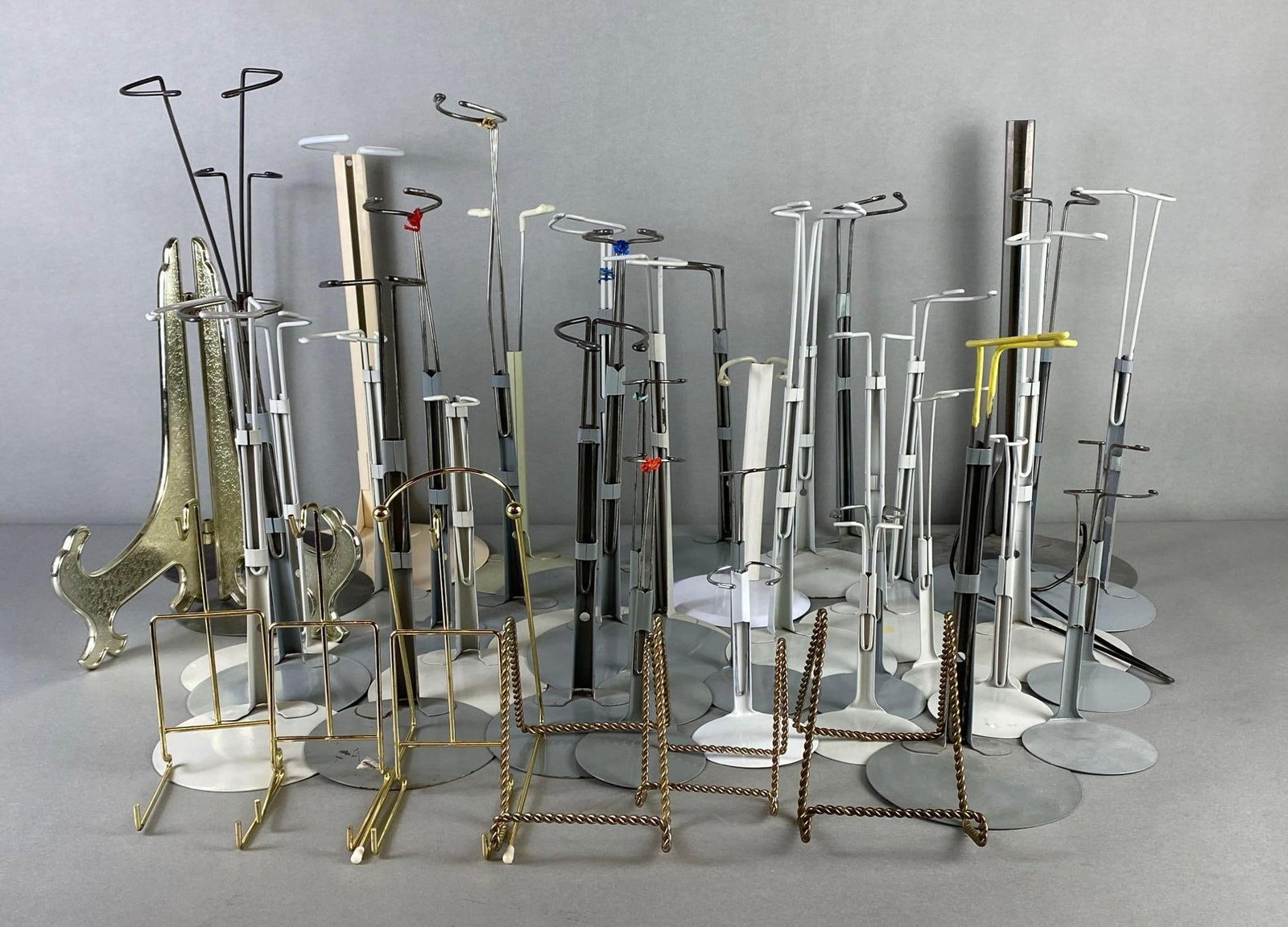 Group of Doll Stands and More: Includes doll stands, plate stands, and more, Largest measures 13 1/2 x 8 x 8 inches.