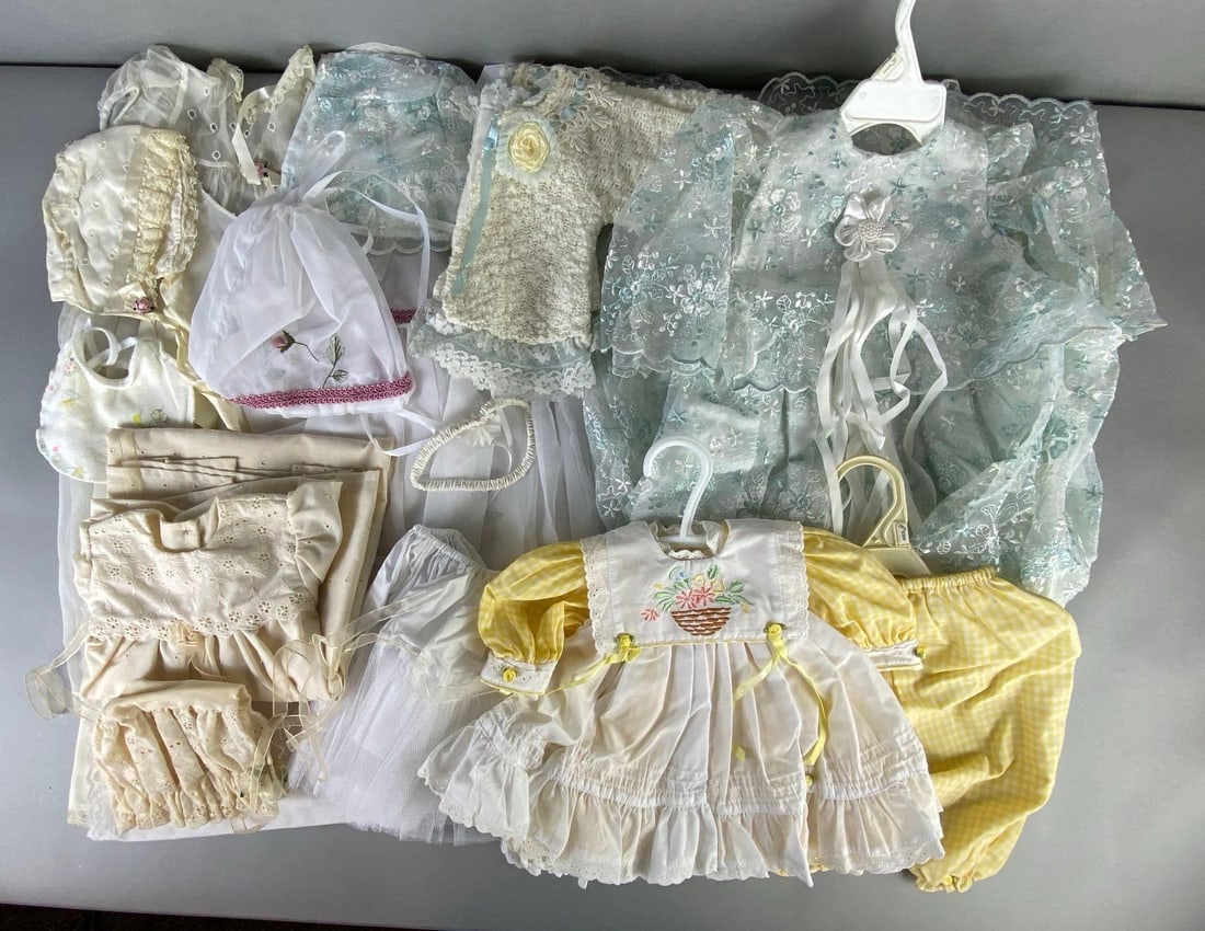 Group of Childrens and Doll Clothing: Includes dresses, bonnets, pants, and more, Largest measures 36 inches long.