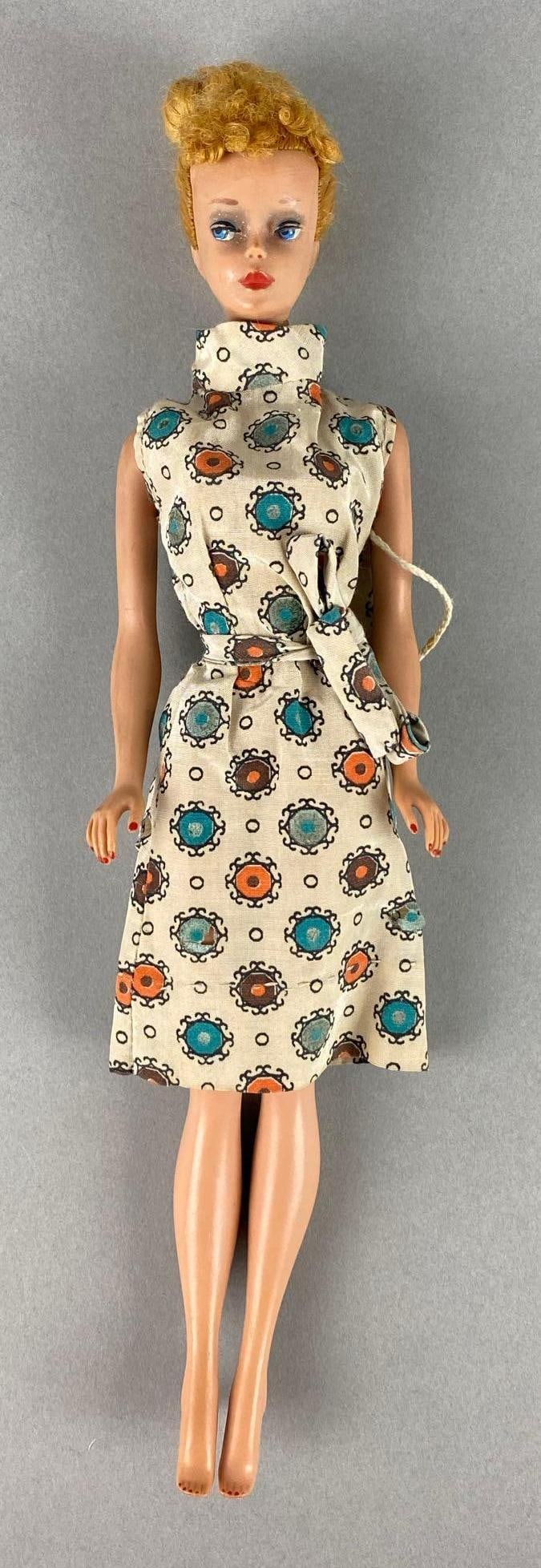 Vintage Mattel Ponytail Barbie Fashion Doll: Dressed in a mid century modern dress with purse. Ears have black dots. Discoloring with age. Measures 12 inches.