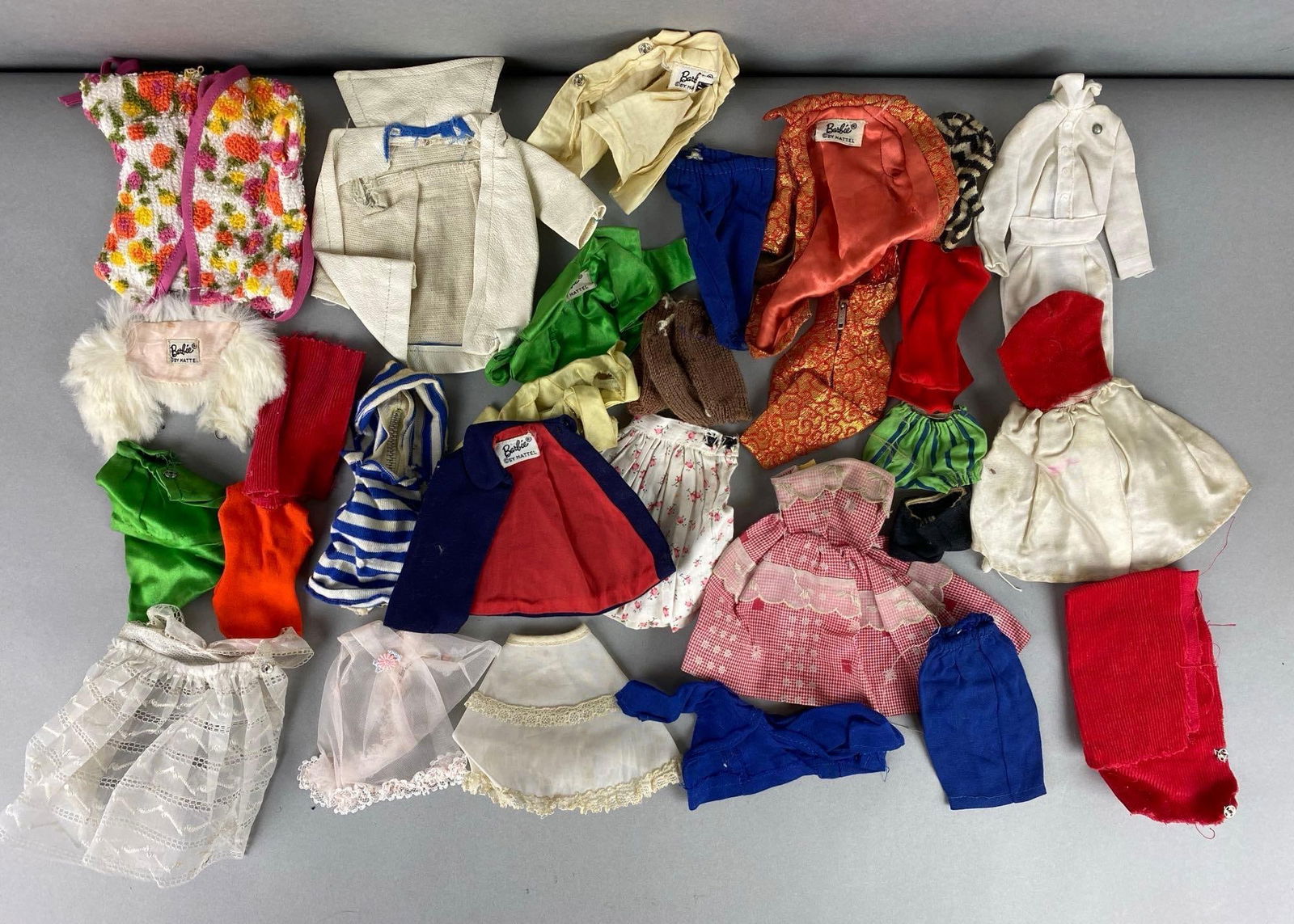 Group of Vintage Mattel Barbie Clothing and more: Some clothing has Barbie tags some look homemade. Largest item measures 6 x 6 inches.