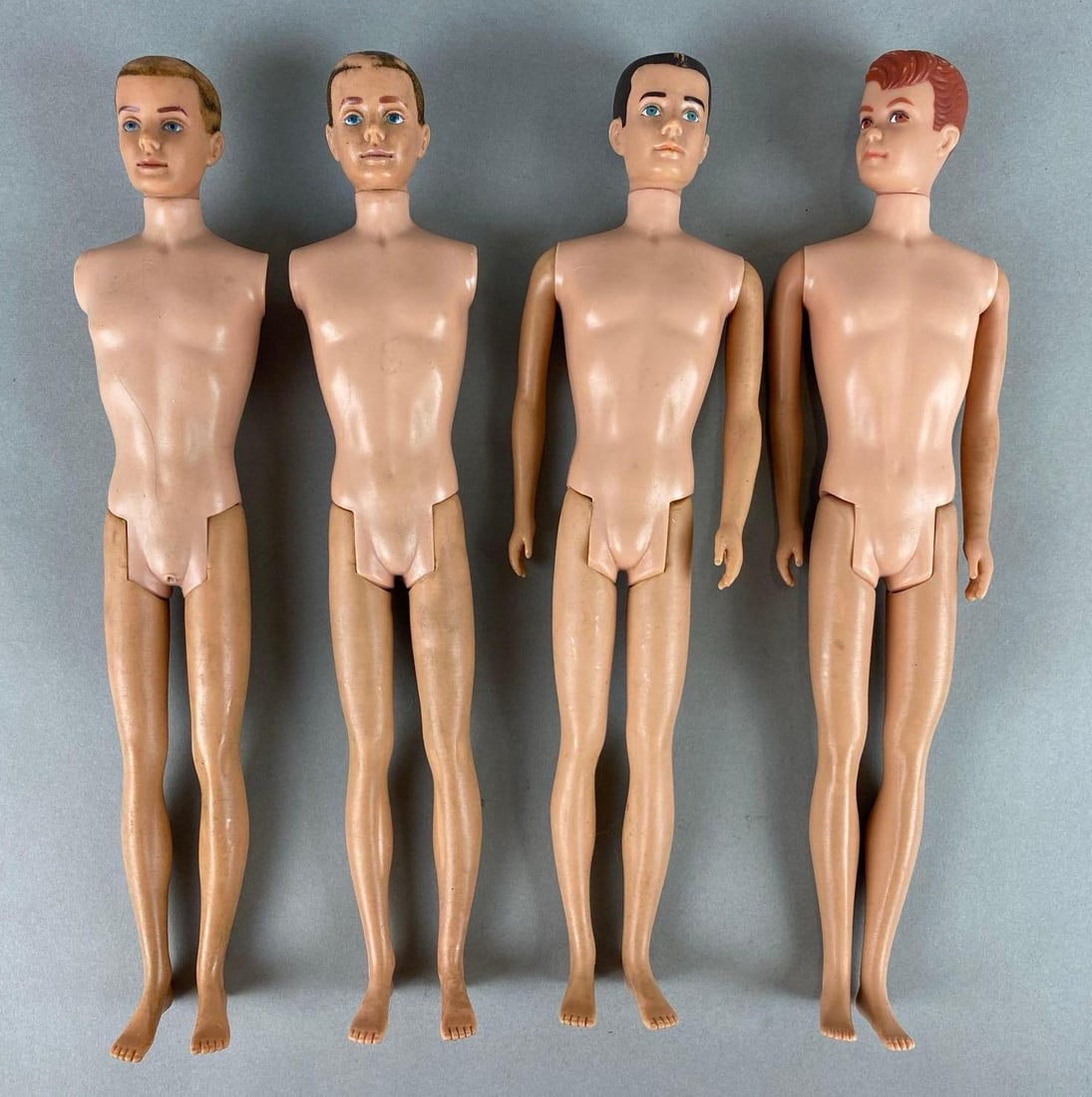 Group of 2 Vintage Mattel Ken Dolls and More: Includes two armless Ken dolls. Wear with age. Largest measures 12 inches.