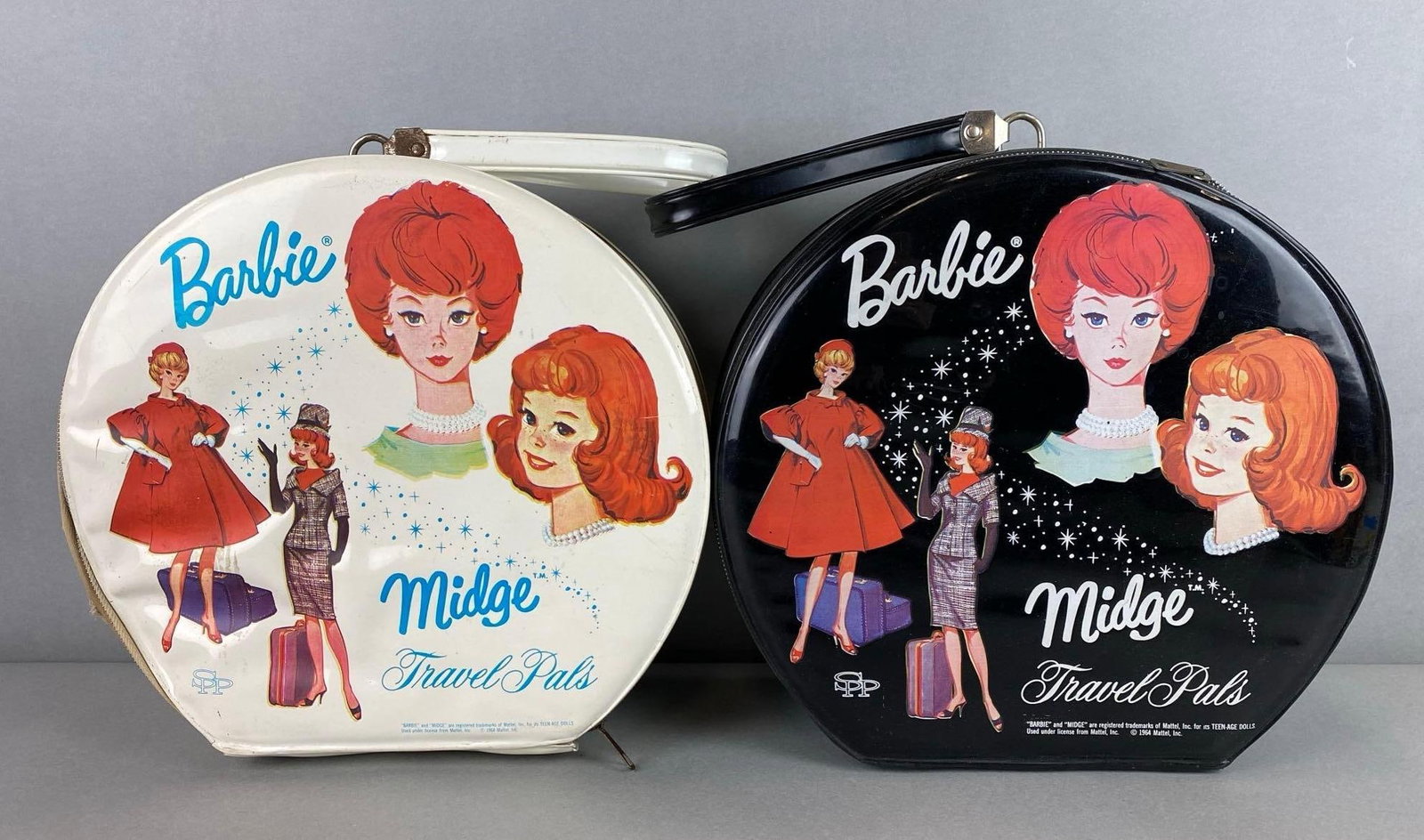 Grouo of 2 Barbie and Midge Travel Pals Cases: Black and white variations. Wear with age. Largest case measures 12 x 11 1/2 x 4 inches.