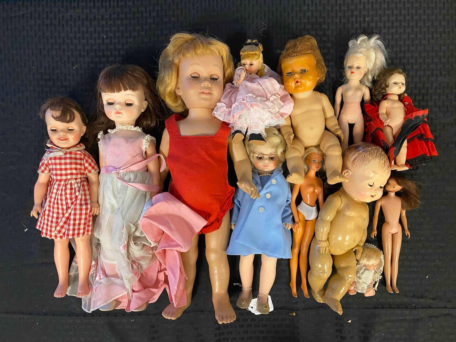 Group of Vintage Baby Dolls and Dolls: Madame Alexander Grandma, Linda Williams doll, skipper Barbie Doll and more. Largest doll measures 20 inches.