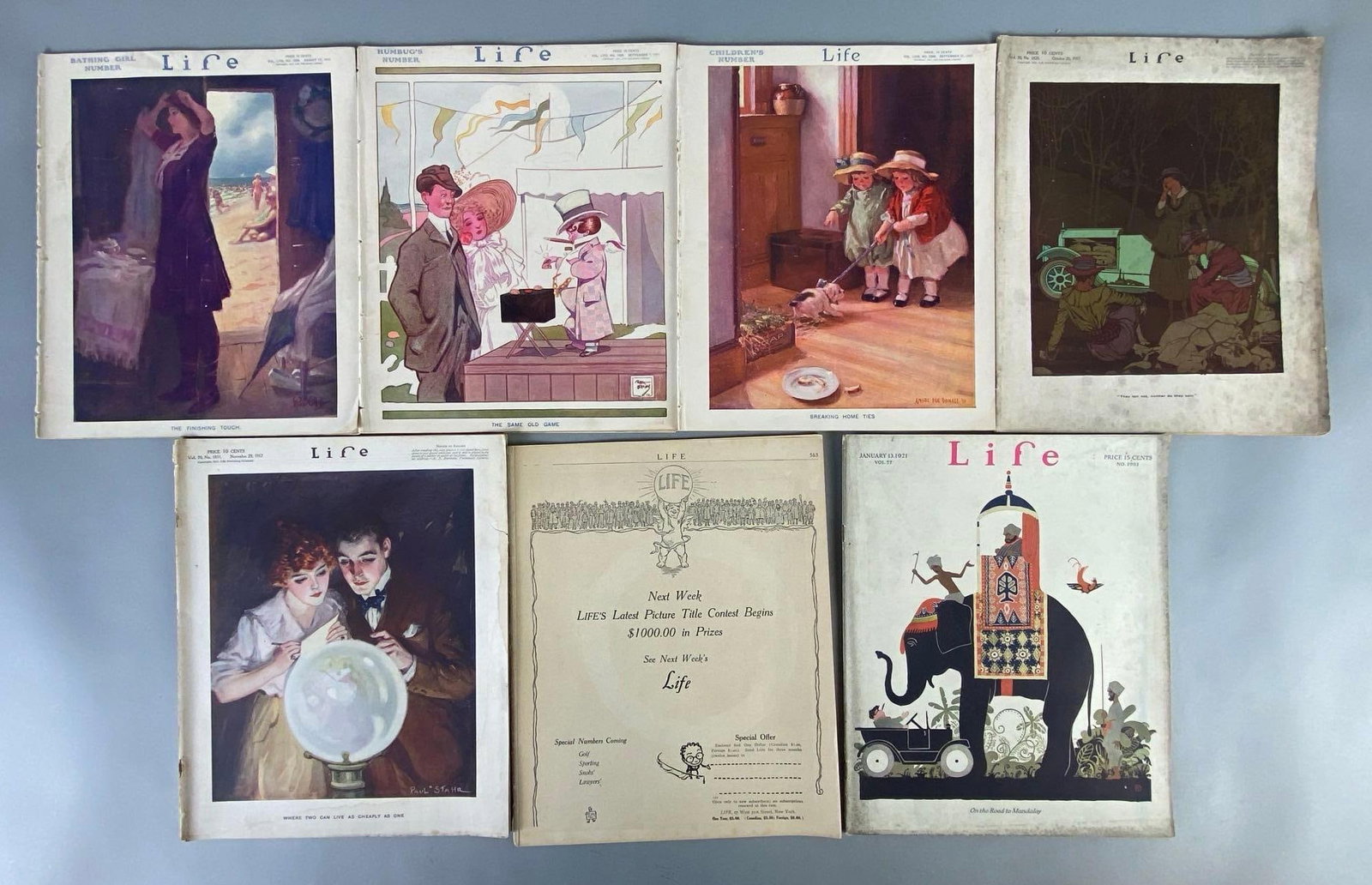 Group of 7 Early 1900s Life Magazines: Rare, Includes 1911, 1917, 1920, and 1924, One missing front cover, Some wear around edges, All measure 11 x 9 inches.