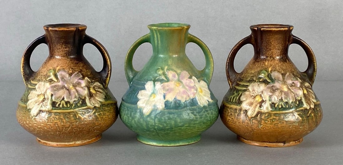 Group of 3 Roseville Pottery Cosmos Amphora Vases: Pattern No. 944-4, Includes green and brown, All measure 4 1/4 x 4 x 4 inches.