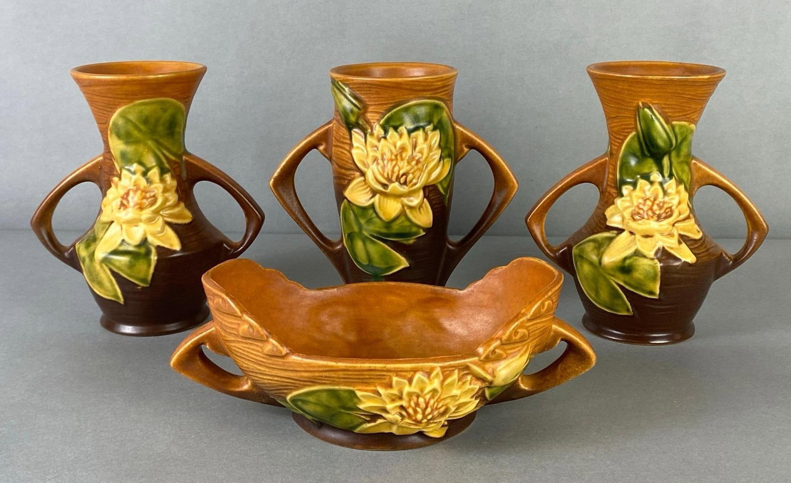 Group oRoseville Pottery Brown Water Lily Vases and More: Includes vases, and console bowl, Tallest measures 6 1/2 x 5 3/4 x 3 3/4 inches.