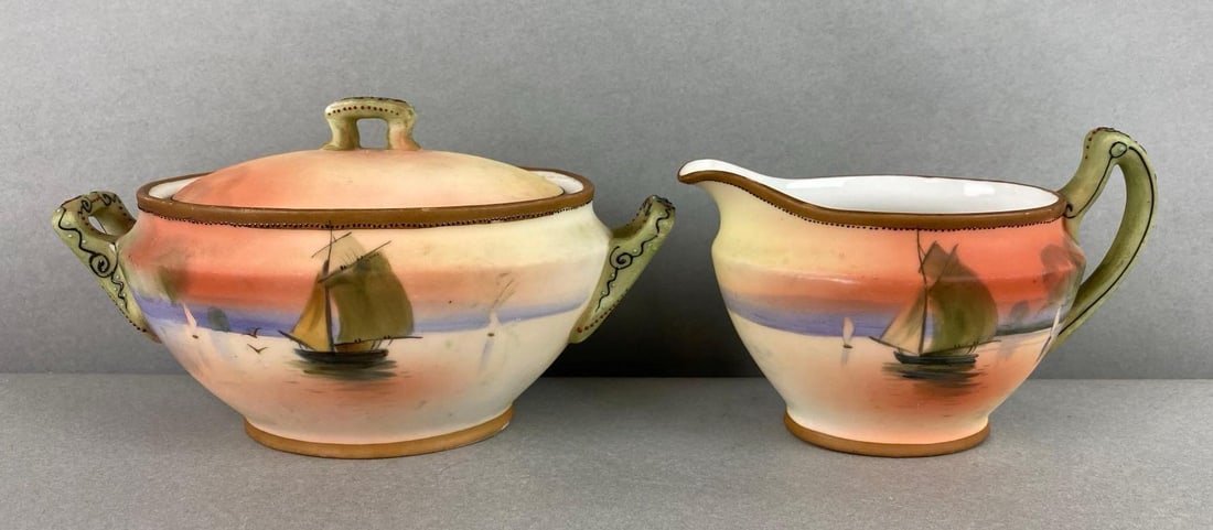 Group of 2 Nippon Hand Painted Porcelain Sugar and Creamer: Depicts boats sailing. Some wear on handles. Largest item measures 2 1/2 x 6 1/2 x 3 1/2 inches.