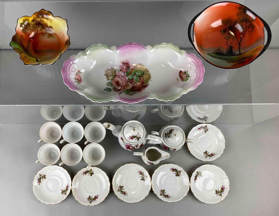 Group of 18 Hand Painted Porcelain Tea Set and More: Features PAl Japan, Noritake and Leuchenberg Germany brands. Includes kettle, bowl, tea saucer and more. Largest item measures 7 x 7 x 3 inches.