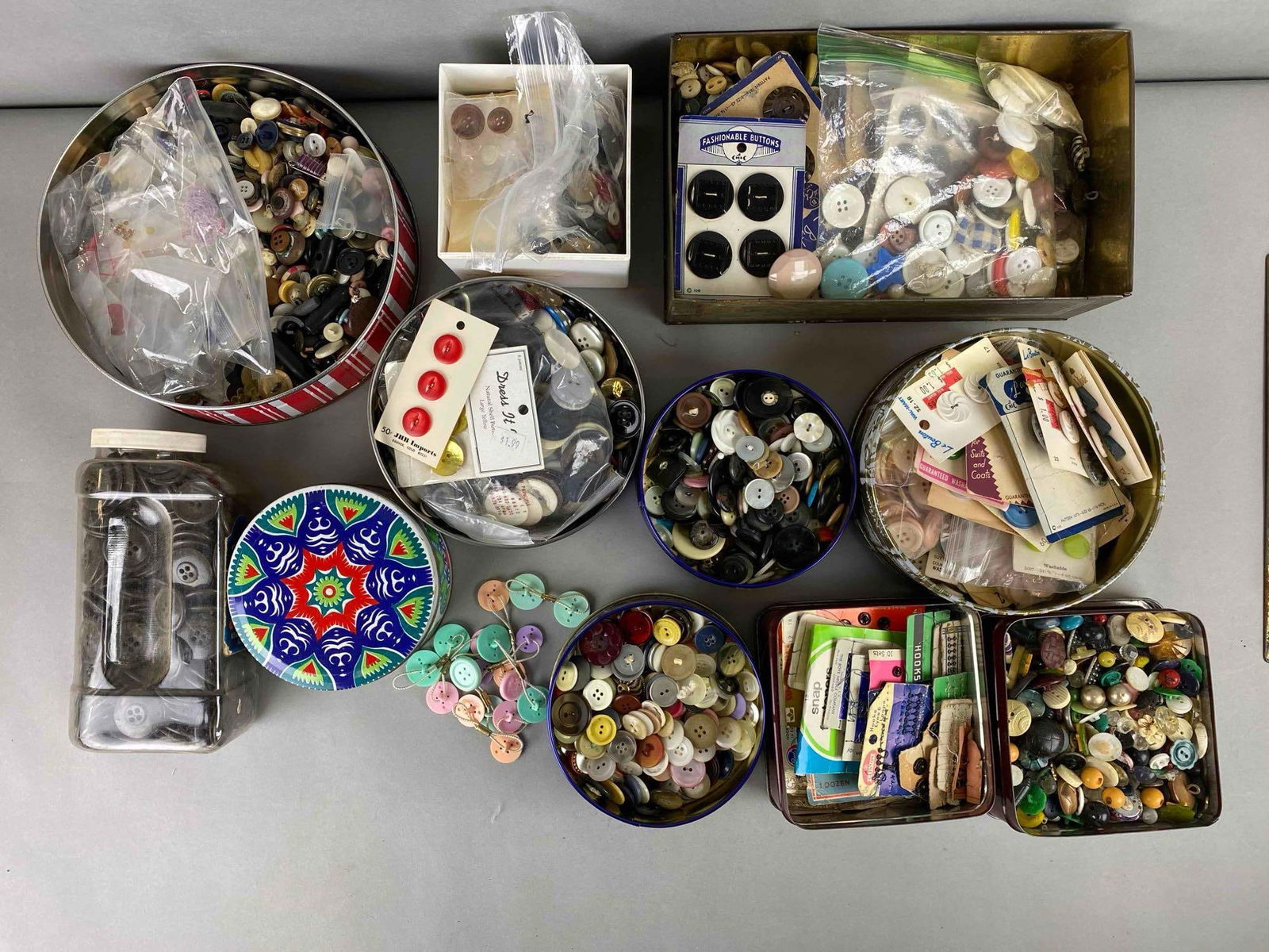 Group of Vintage Buttons and More: Includes dress fastener, button hair ties, hooks and more. Largest tin measures 3 1/3 x 10 3/4 x 6 1/4 inches.