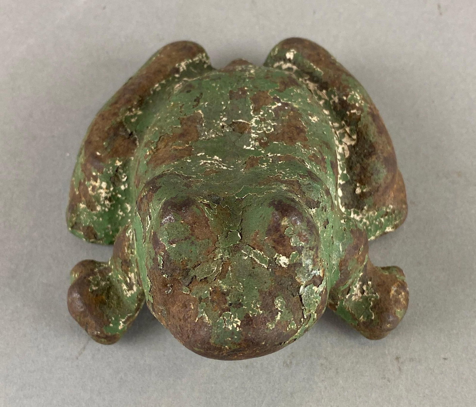 Vintage Cast Iron Frog Doorstop: Green and rust. Does have wear with age. Measures 3 1/4 x 4 1/2 x 5 1/4 inches.