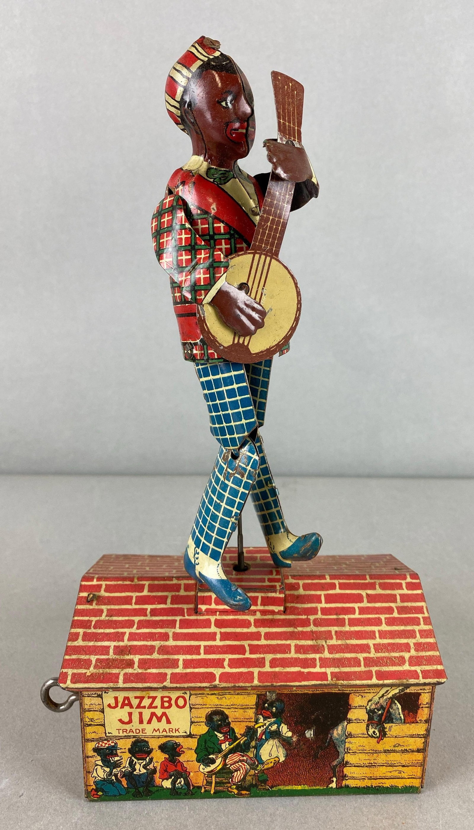 Unique Art Tin Litho Wind Up Toy Jazzbo Jim Black Americana with Original Box: Includes original box. dancer on the Roof. Wear with age. Can hear mechanics attempting to work. Toy measures 10 x 5 1/2 x 3 1/4 inches.