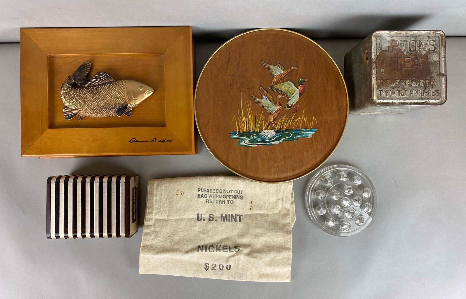 Group of Assorted Items: Includes flower frog, vintage Bulova watch case, tins and more. Largest item measures 2 1/4 x 8 1/4 x11 inches.