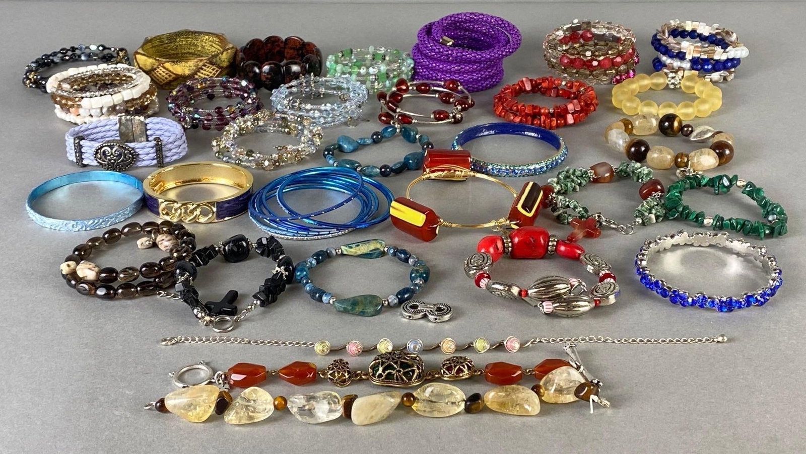 Group of Costume Jewelry Bracelets: Includes rhinestone, bangles, beaded, coiled, and more.
