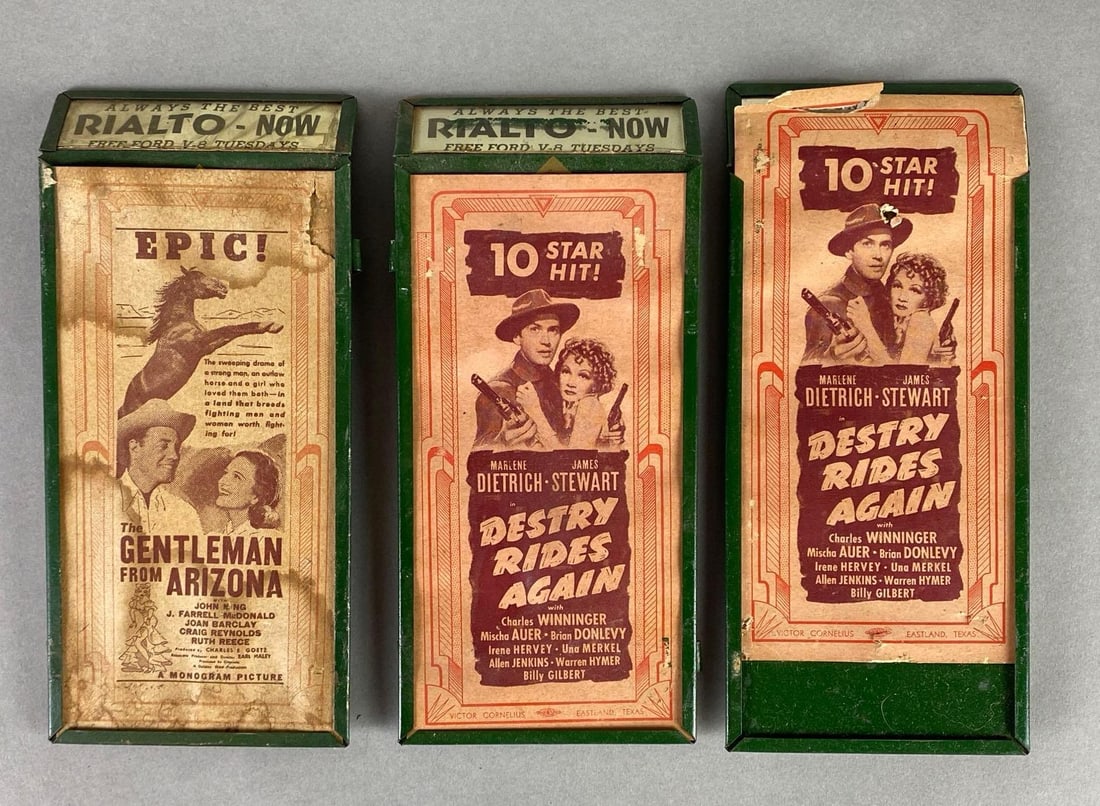 Group of 3 Drive-In Movie Advertising Ephemera: Meant to be hung on speakers at drive-in theaters, Includes The Gentleman from Arizona, and Destry Rides Again, Some tears and moisture damage, attached to metal plates, All measure 8 x 3 1/2 x 1 inch