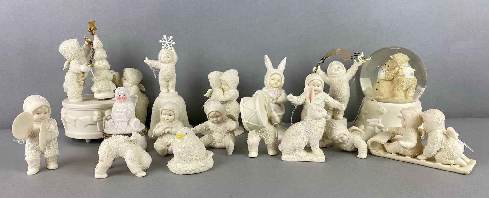 Group of 17 Snowbabies Figures: Includes music box, snow globe, trinket box and more. Largest item measures 7 x 5 1/4 x 4 inches.