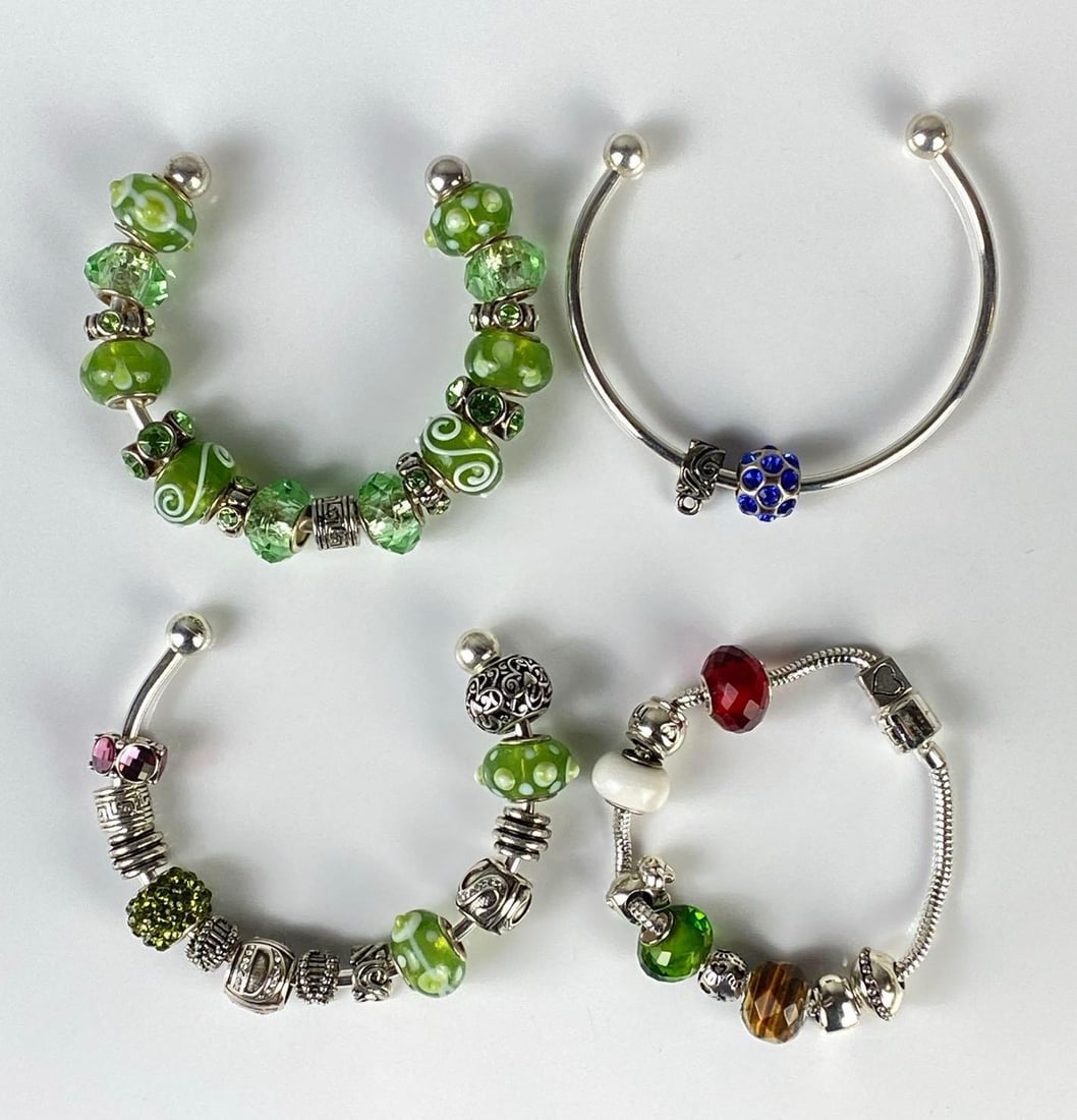 Group of 4 Pandora Bracelets with Beads: Includes beads and charms, Majority green or silver in color, Largest bracelet measures 6 3/4 inches around.
