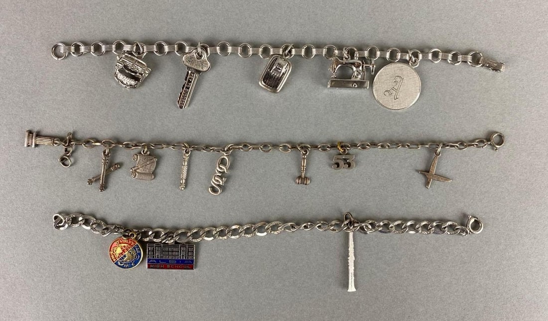 Group of Sterling Silver Charm Bracelets: Sterling silver. Weighs 43.6 grams. Includes sewing machine, gavel, type writer and more. Largest bracelet measures 7 inches.