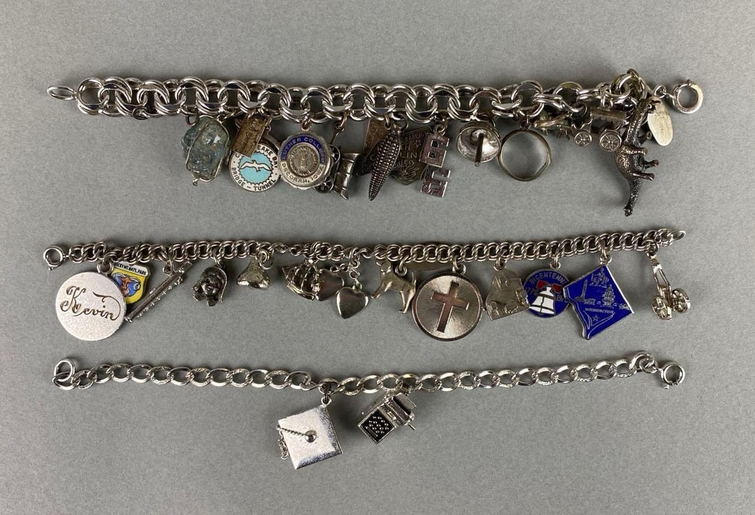 Group of Sterling Silver Charm Bracelets: Sterling silver. Weighs 101.9 grams. Includes cross, graduation cap, ear of corn and more. Bracelet measures 7 inches.