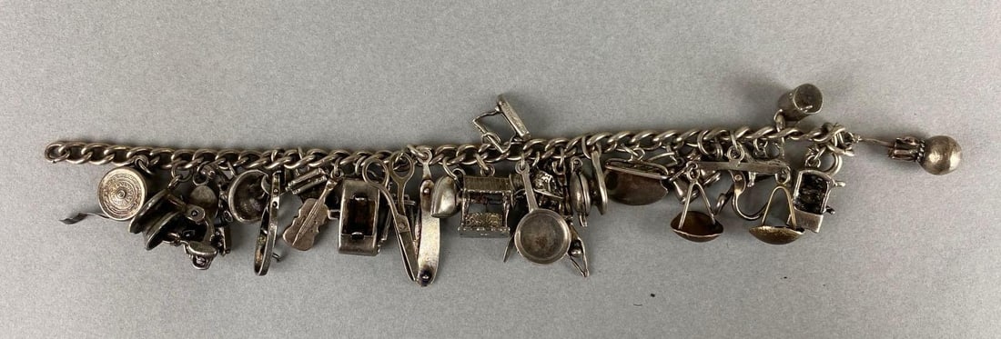 Vintage Sterling Silver Charm Bracelet: Sterling silver. Weighs 49.3 grams. Includes scale, violin, stand mixer and more. Bracelet measures 6 3/4inches.
