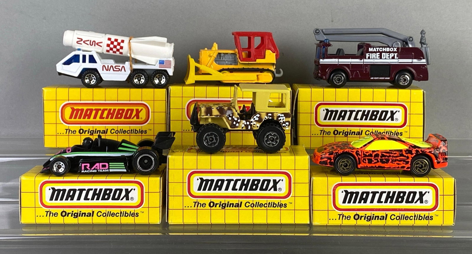 Group of 6 Matchbox Die-Cast Cars: Includes No. 65 racer, No. 64 bulldozer, No. 20 Jeep Laredo and more, with boxes