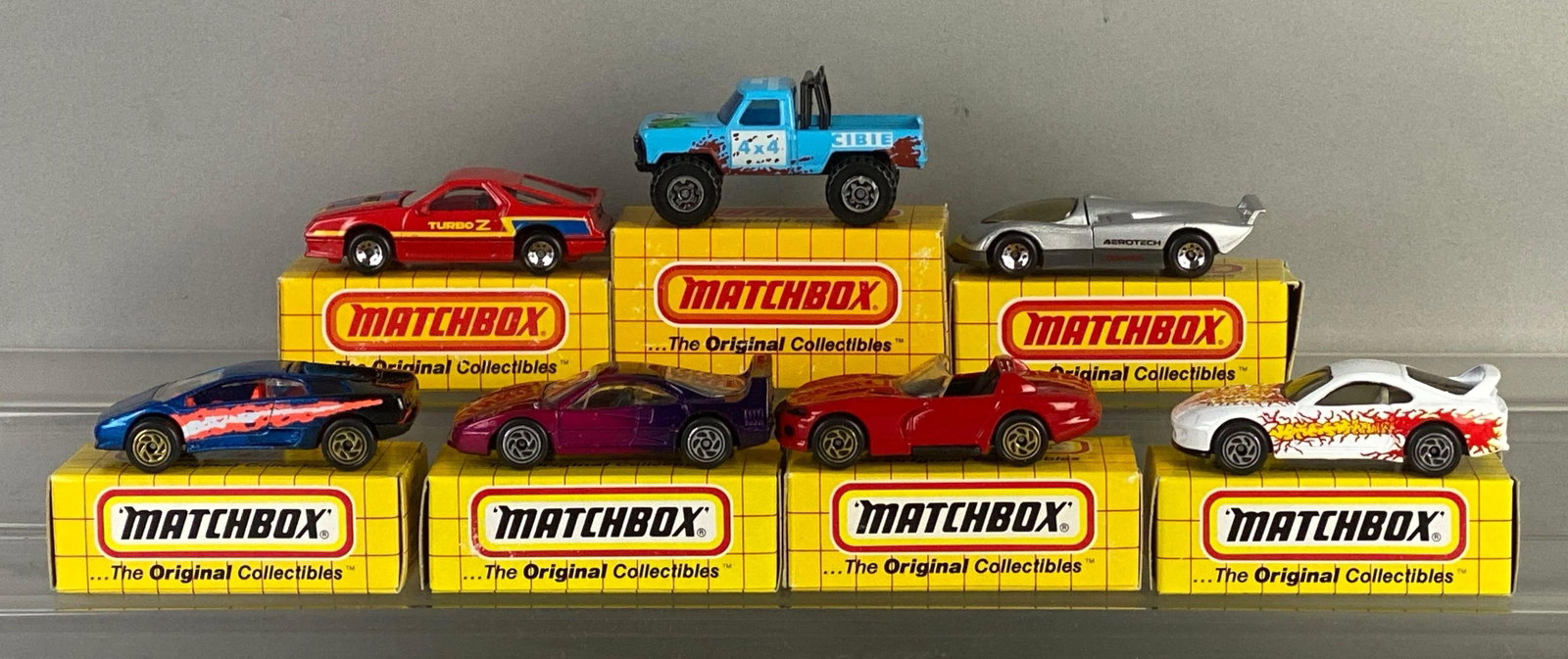 Group of 7 Matchbox Die-Cast Cars: includes No. 62 Oldsmobile aero tech, No. 24 Ferrari, No. 57 mountain man and more, with boxes